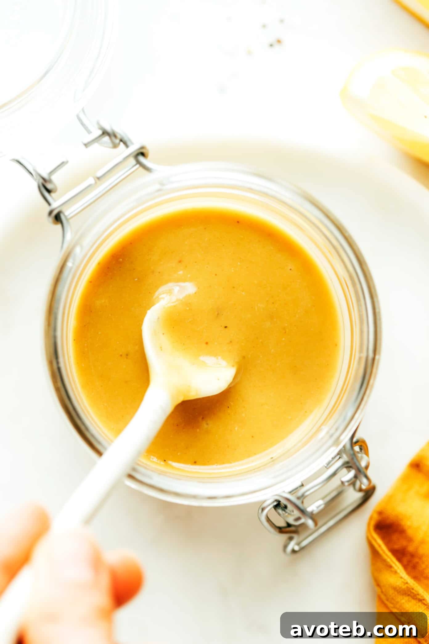 Luminous Caesar-ish dressing, an anchovy vinaigrette, showcased in a elegant glass jar, perfect for culinary inspiration.