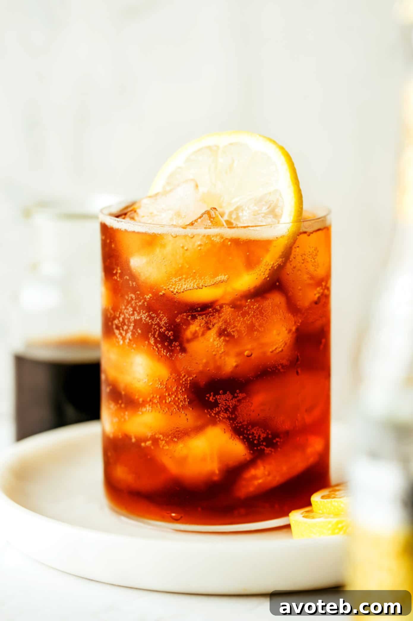 A glass of Cold Brew Tonic with a vibrant lemon slice and condensation, ready to be enjoyed.