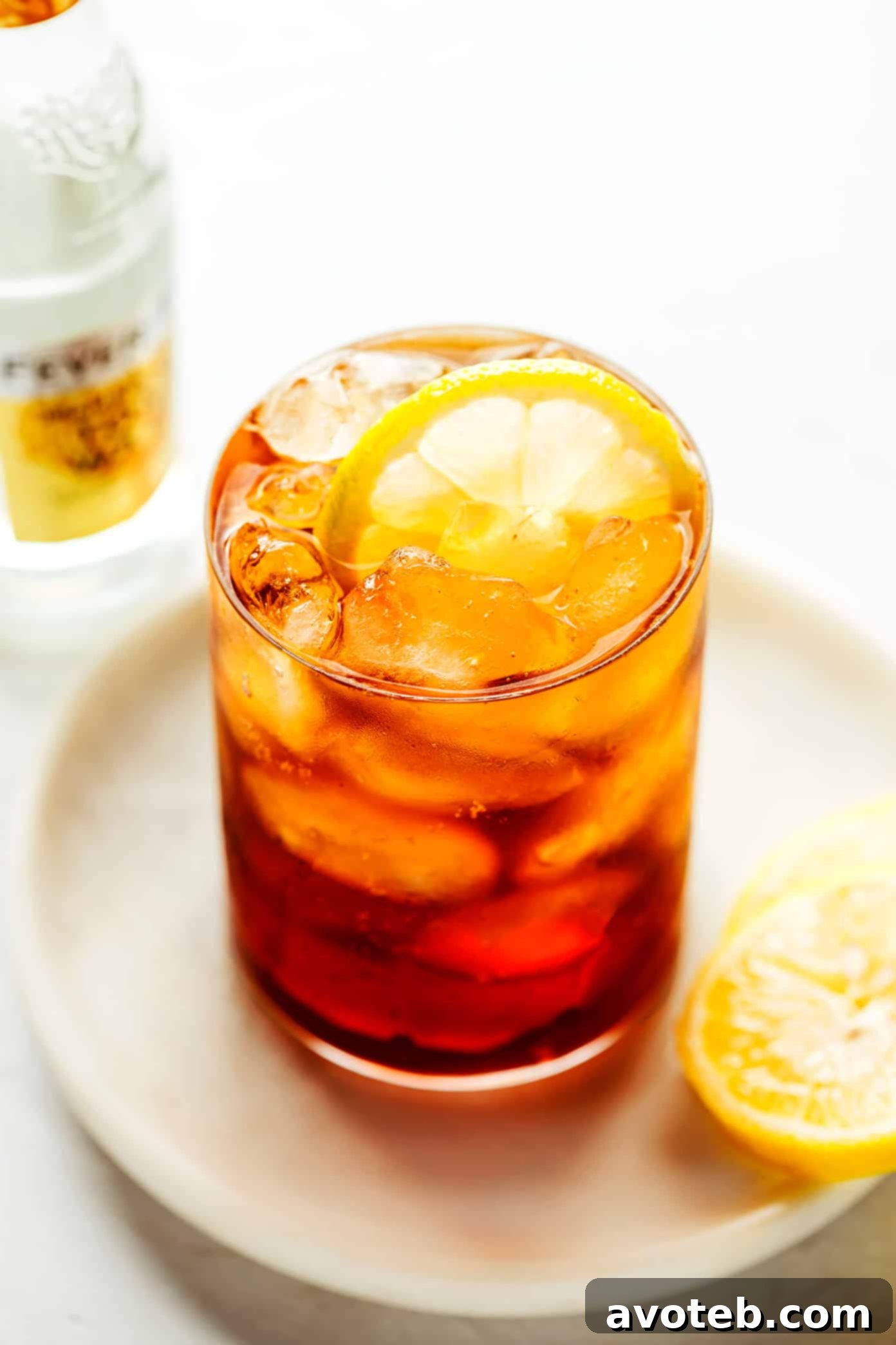 A top-down view of a Cold Brew Tonic in a glass with a lemon slice, on a textured surface.