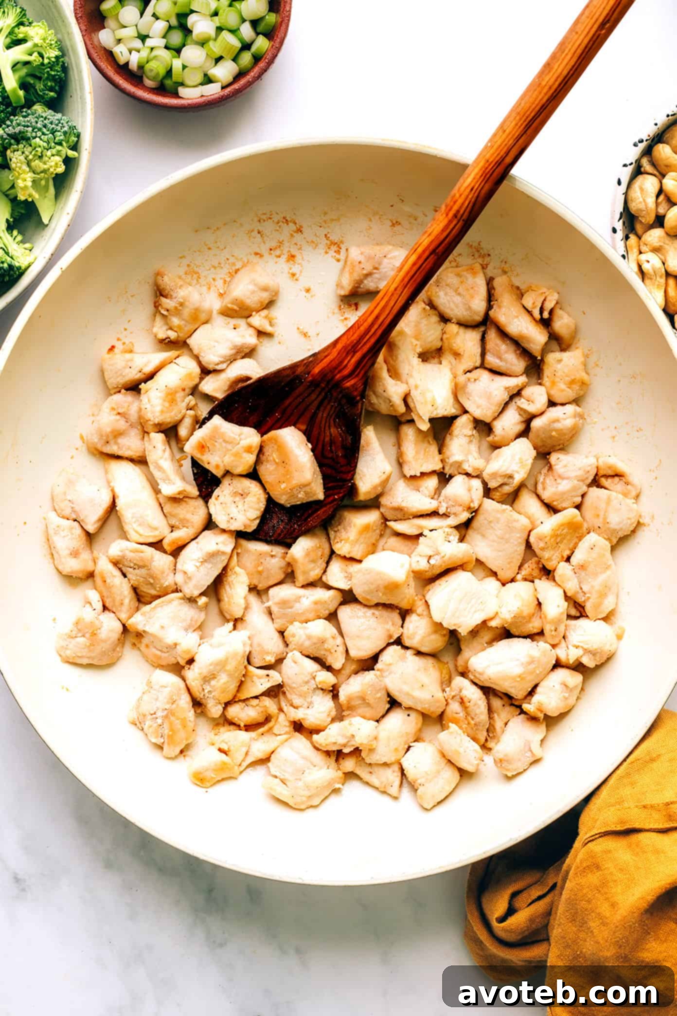 Plated Cashew Chicken and Broccoli Stir-Fry with sauce