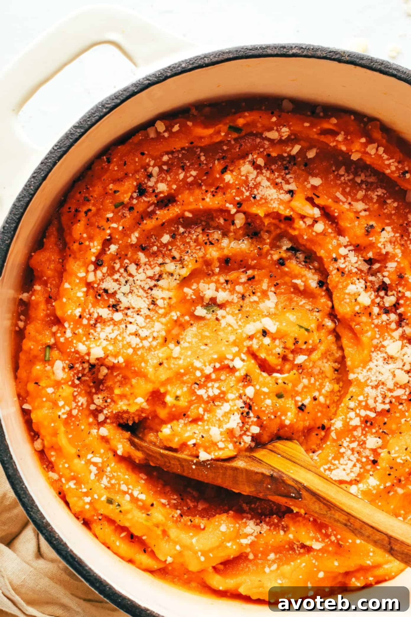 Garlic Parmesan Mashed Sweet Potatoes served warm in a rustic pot, ready to be enjoyed.
