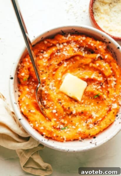 Garlic Parmesan Mashed Sweet Potatoes with a pat of butter melting on top.
