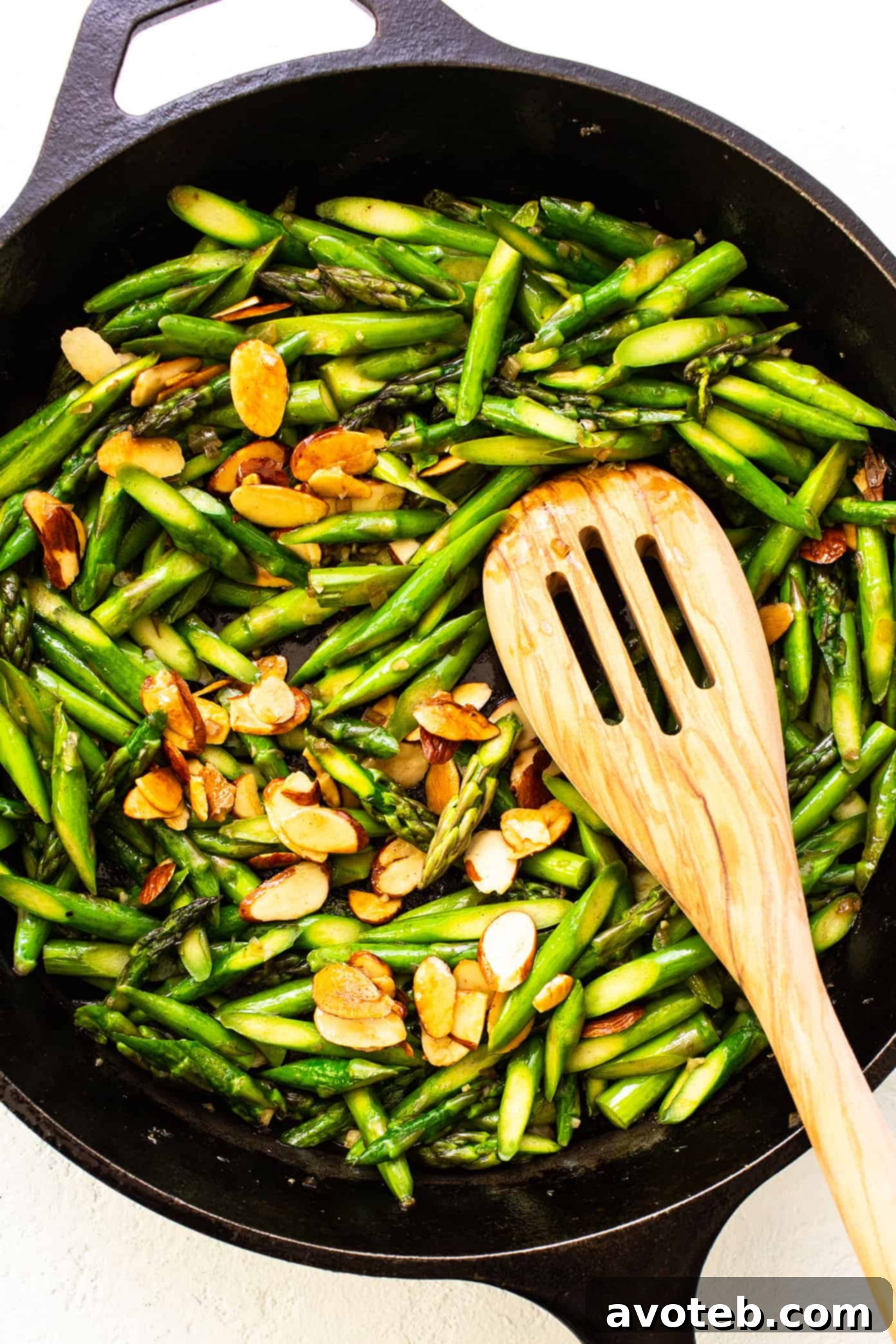 Asparagus with Toasted Almonds 4 A close-up shot of the fresh ingredients for Asparagus Almondine, including asparagus, lemon, almonds, and shallots.