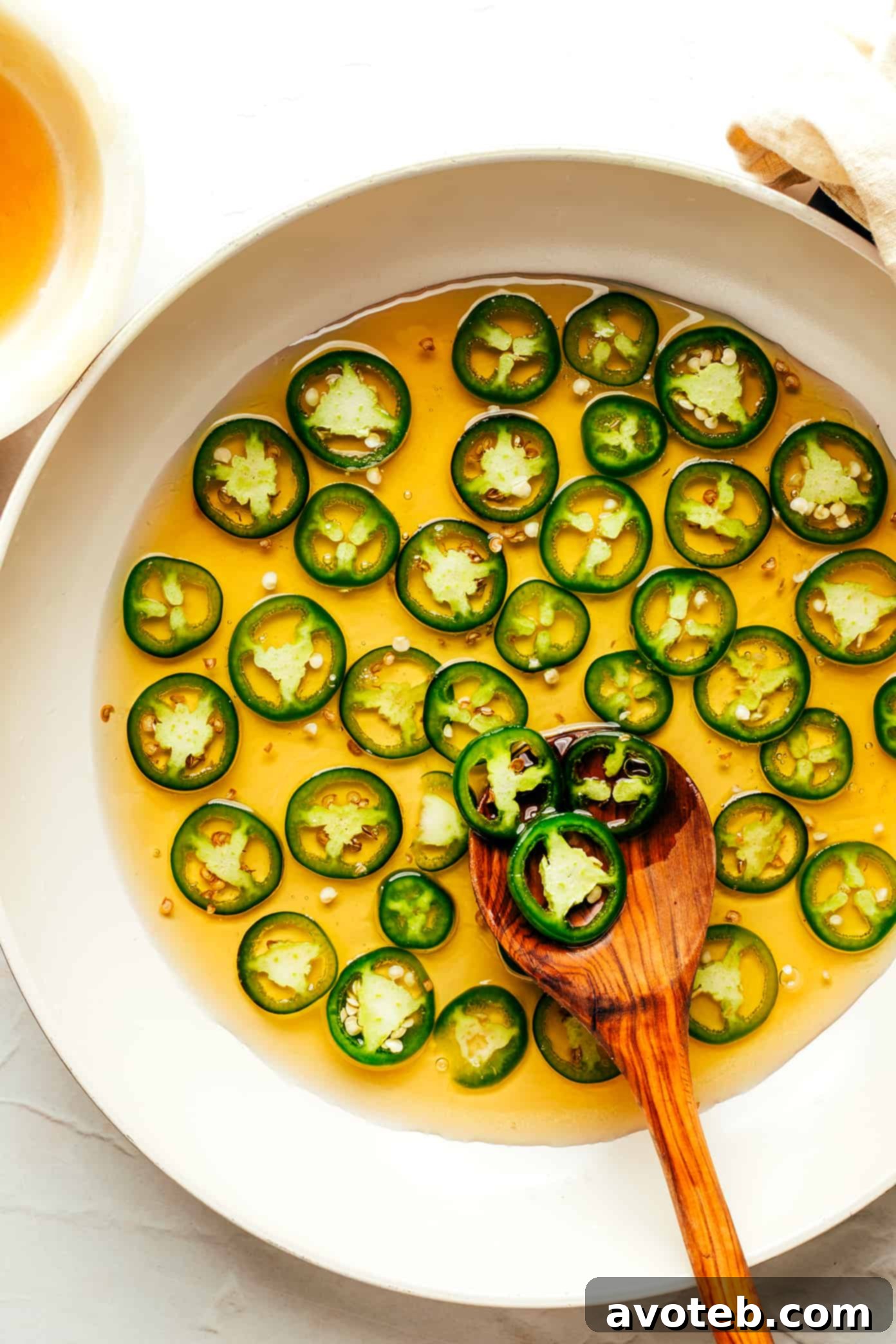 Making homemade hot honey with jalapeno peppers