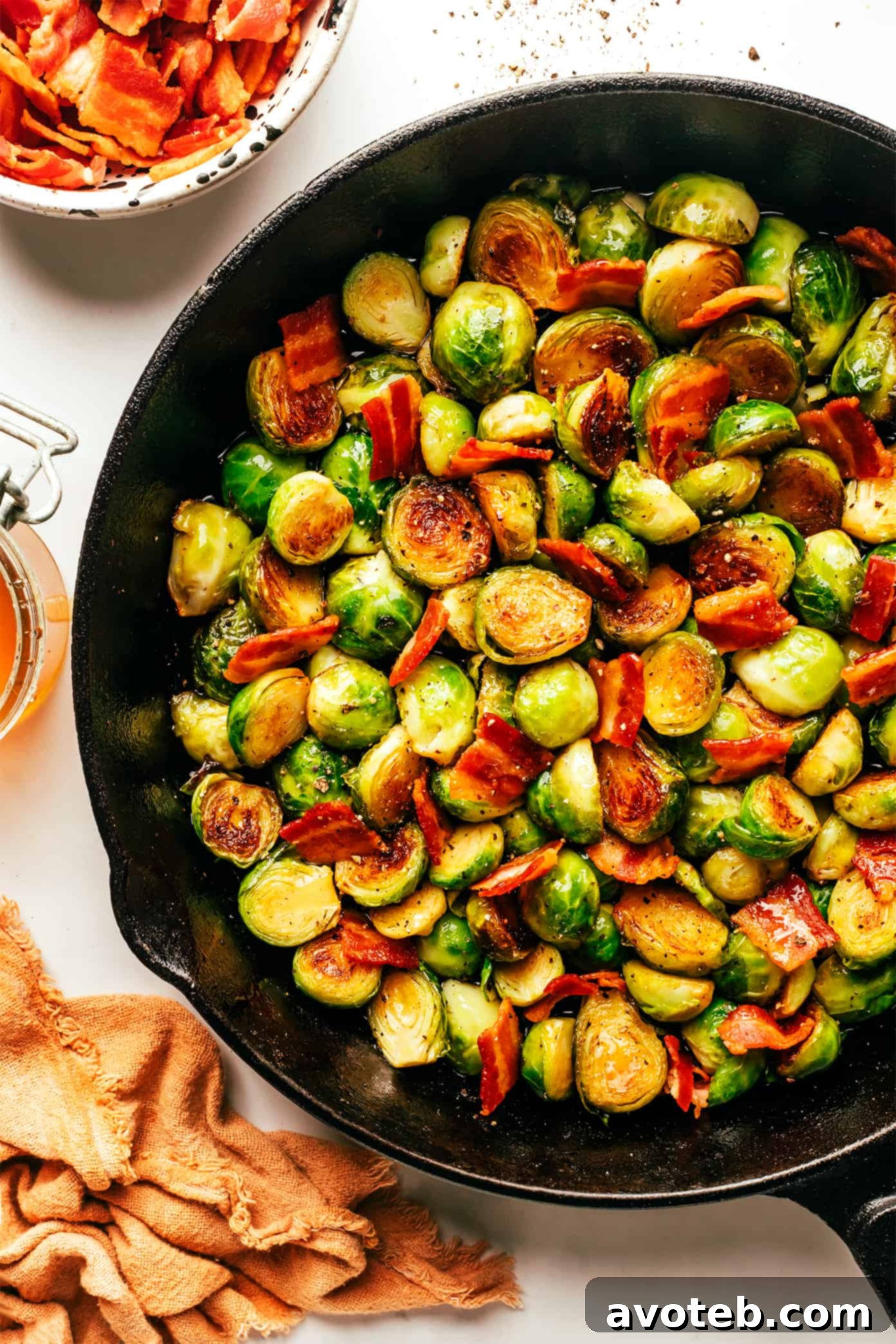 These bacon Brussels sprouts are easy to make and tossed with an irresistible drizzle of hot honey. The perfect side dish for Thanksgiving, dinner parties, or anytime you're just craving some extra-delicious vegetables. Bacon Brussels Sprouts with Hot Honey in Skillet