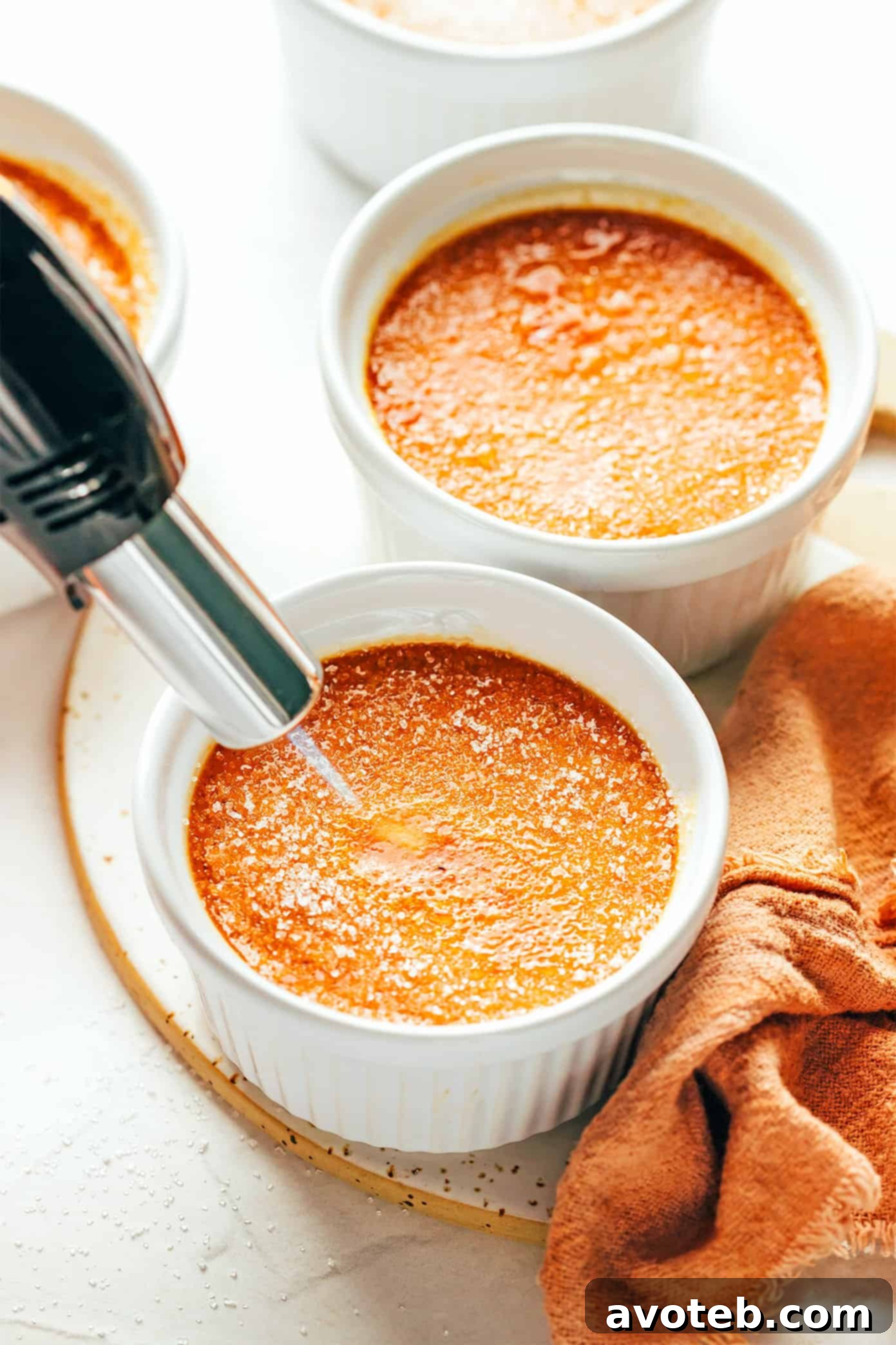 Achieve the perfect caramelized sugar topping with a kitchen torch for your salted caramel crème brûlée. Using a kitchen torch to caramelize the sugar for Crème Brûlée, close up