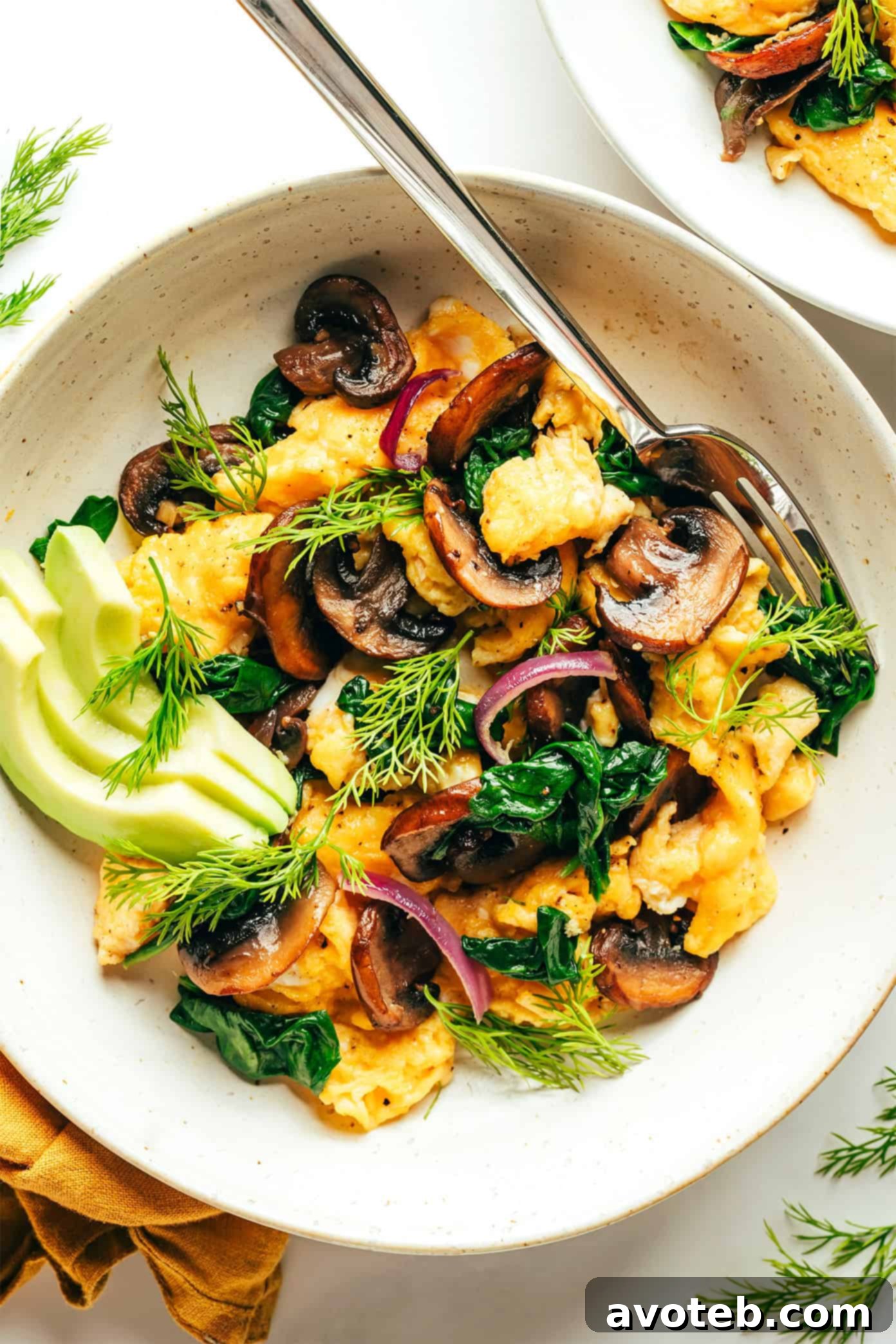 Garden Greens Mushroom Scramble 2 A vibrant and fresh spinach mushroom egg scramble served with avocado slices, ready for a healthy breakfast.