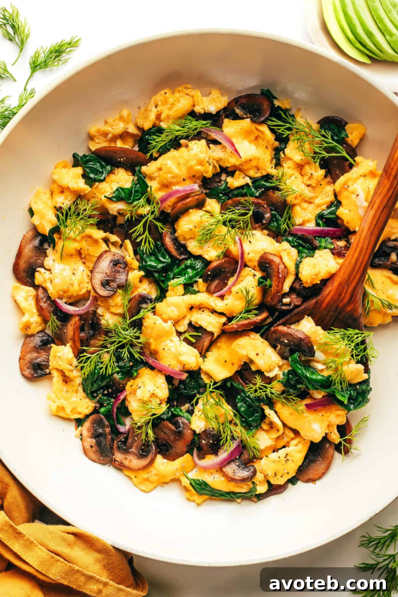 Garden Greens Mushroom Scramble 5 A delicious and wholesome spinach mushroom egg scramble, presented in a rustic skillet with fresh toppings, perfect for a cozy morning.