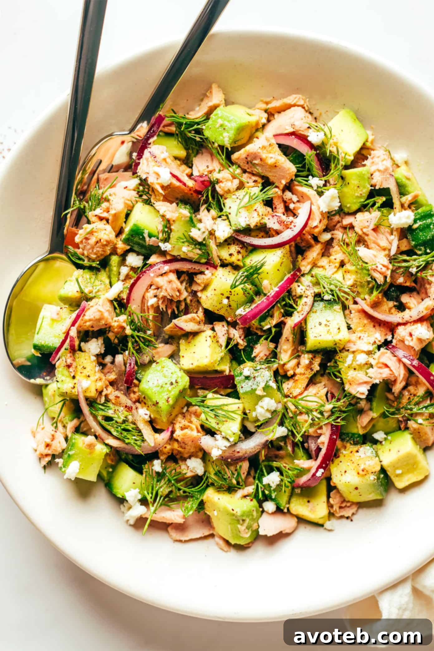Close-up of a fresh Tuna Avocado Brown Rice Bowl garnished with dill and black pepper, ready to be enjoyed.