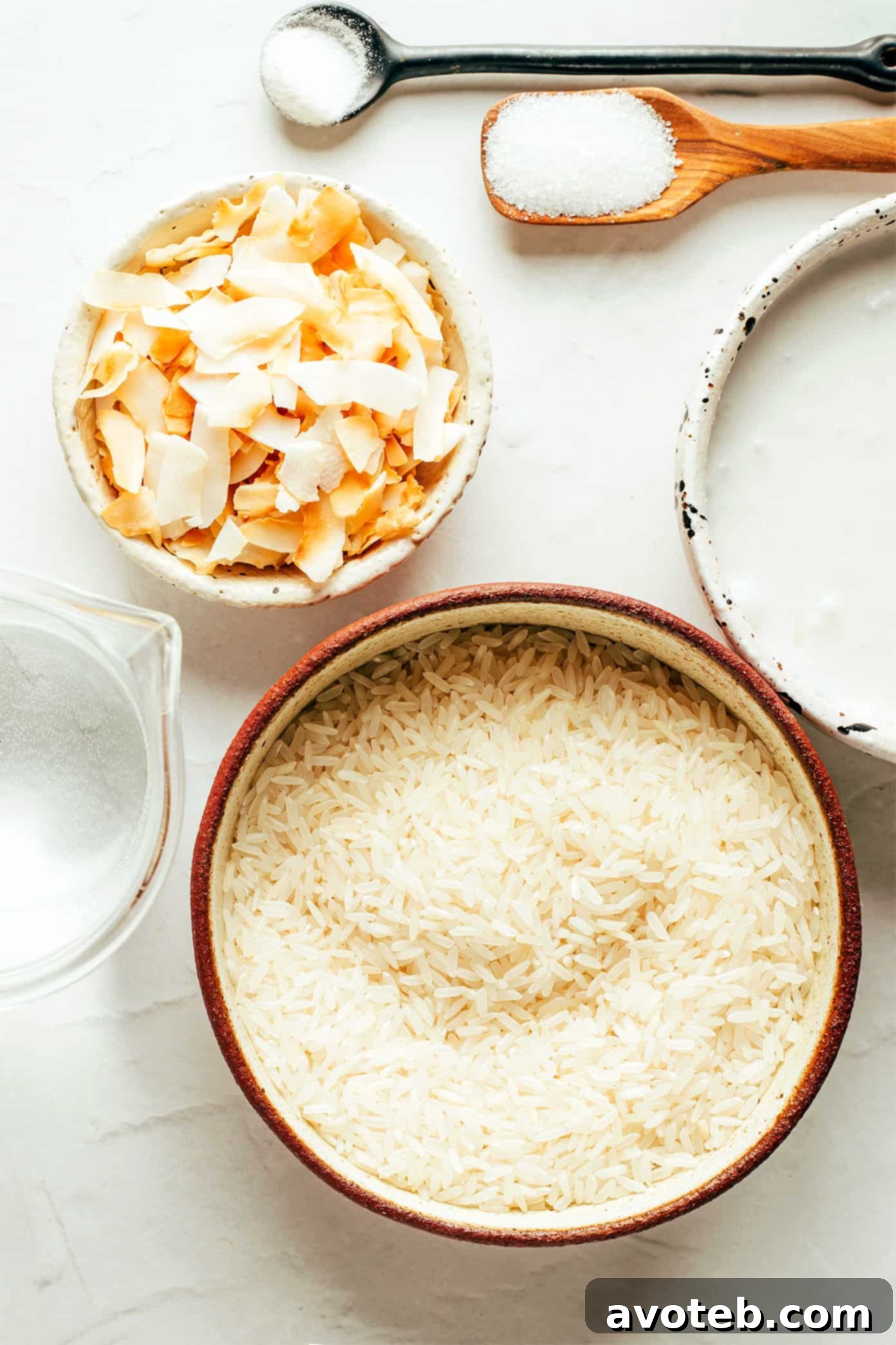 Essential ingredients for making delicious coconut rice: rice, coconut milk, water, salt, and optional sugar.