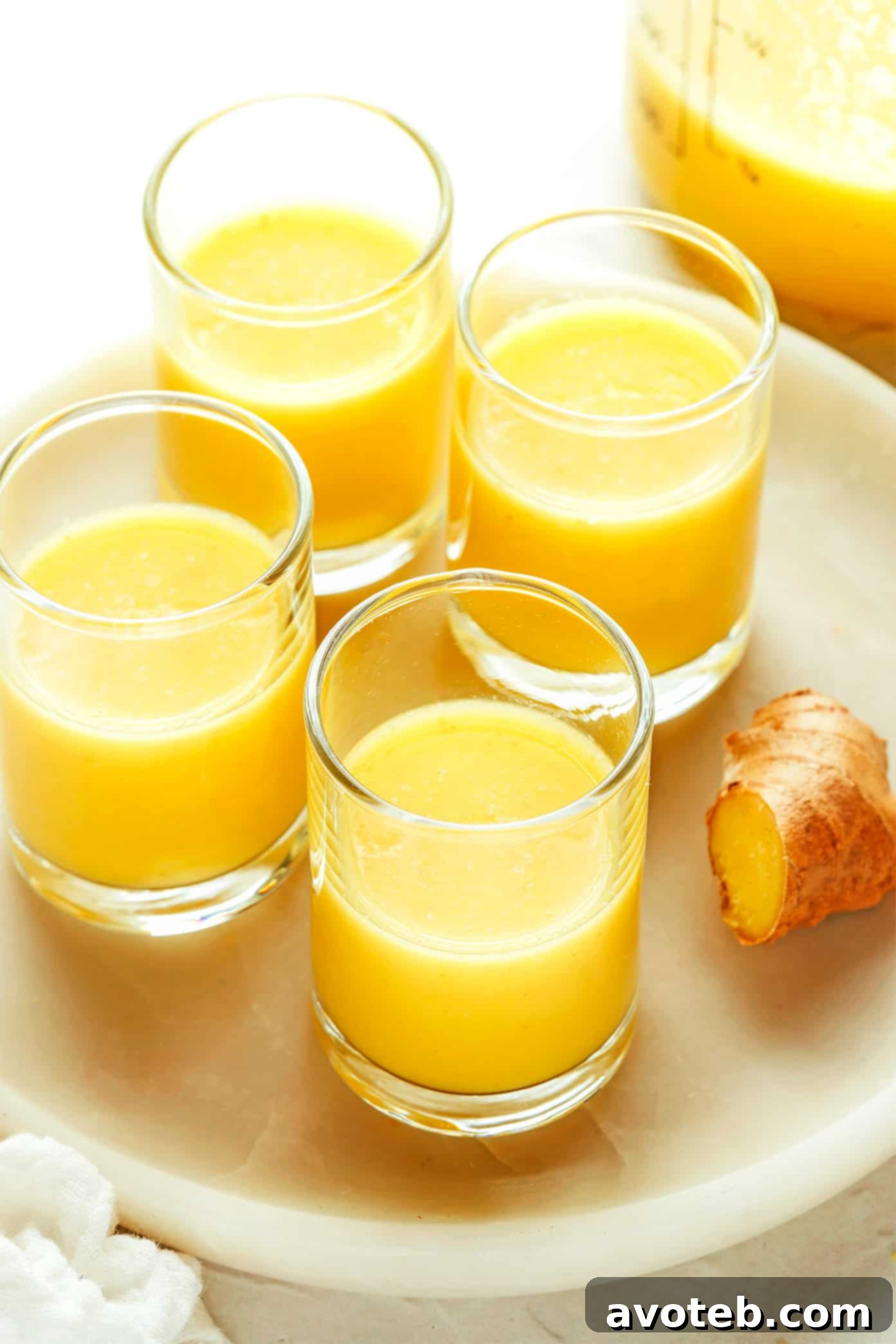 Collection of ginger shots in various small glasses, ready for consumption