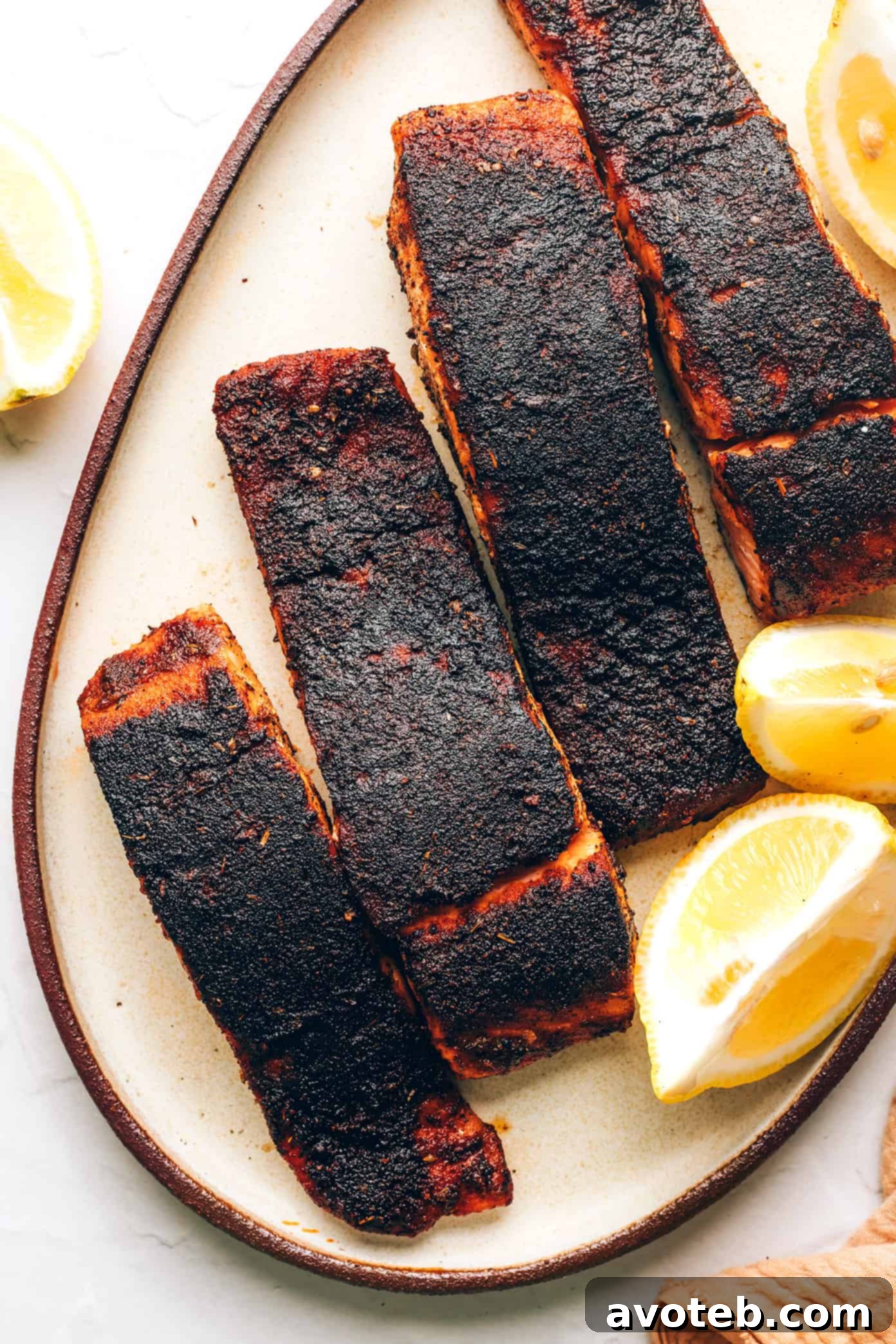 Blackened Salmon served with fresh lemon wedges for garnish