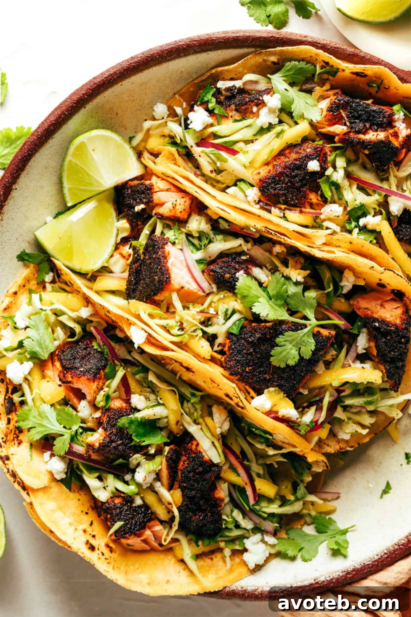 Blackened Salmon Tacos with fresh lime wedges and cilantro