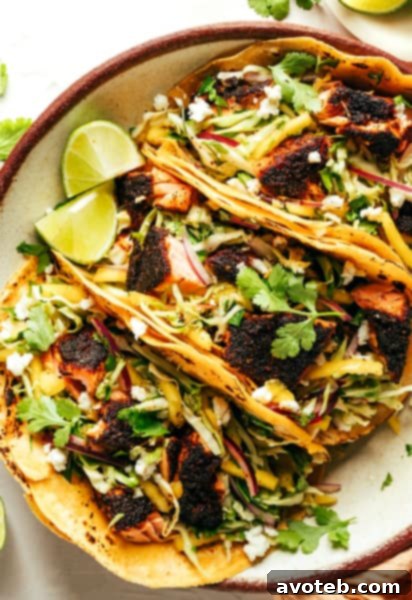 Blackened Salmon Tacos on a plate with fresh ingredients