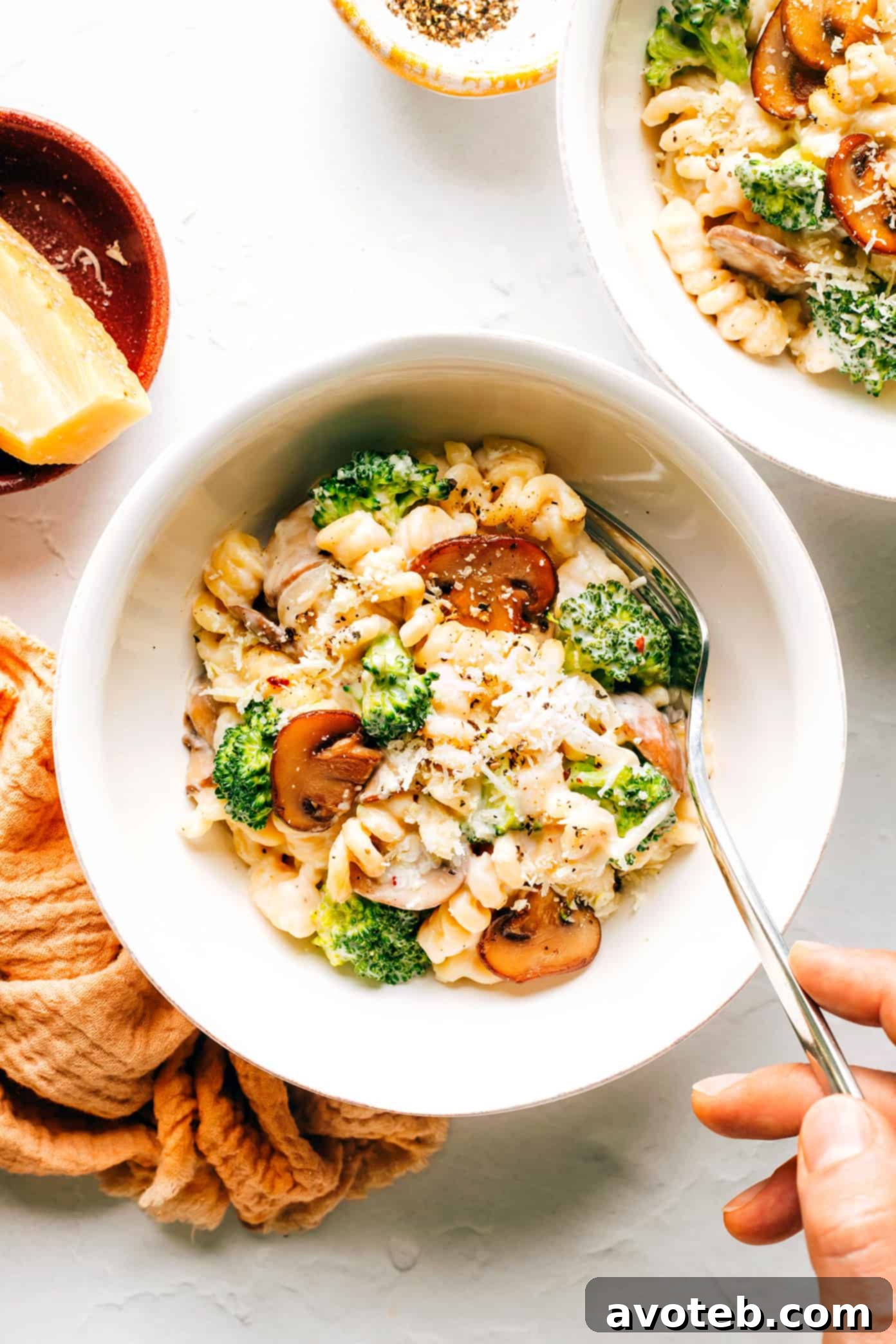 Bowl of hot Broccoli Mac and Cheese with a fork ready to eat