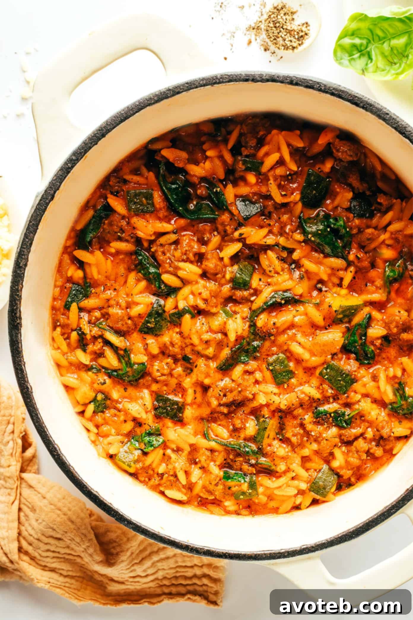 Rustic Italian Sausage Zucchini Orzo 5 A portion of the Italian Sausage Zucchini Orzo served in a bowl, garnished with extra Parmesan and basil, ready to eat.