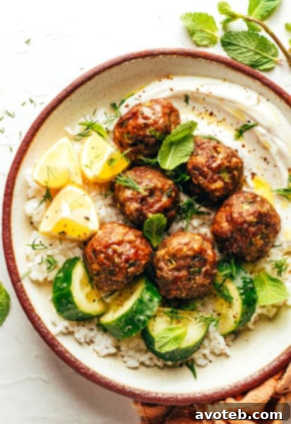Close-up of Greek Meatballs with tahini yogurt sauce and fresh herbs