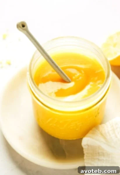 Homemade lemon curd in a clear jar, ready to serve