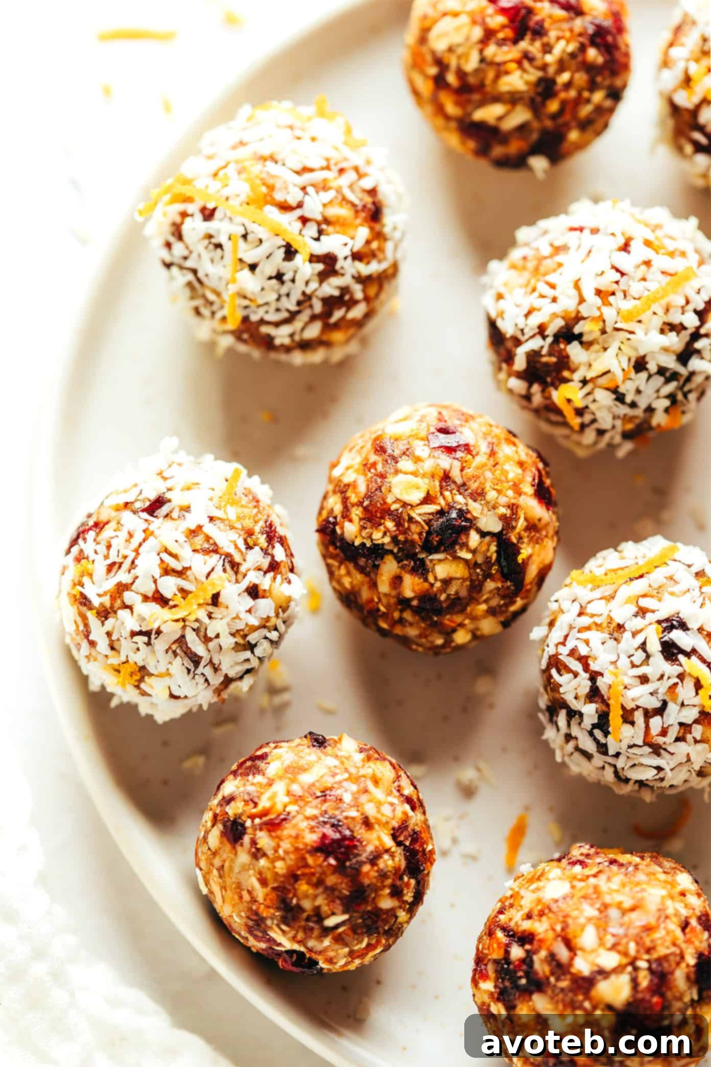 The final spread of cranberry orange almond energy bites, beautifully presented with a garnish of orange zest.