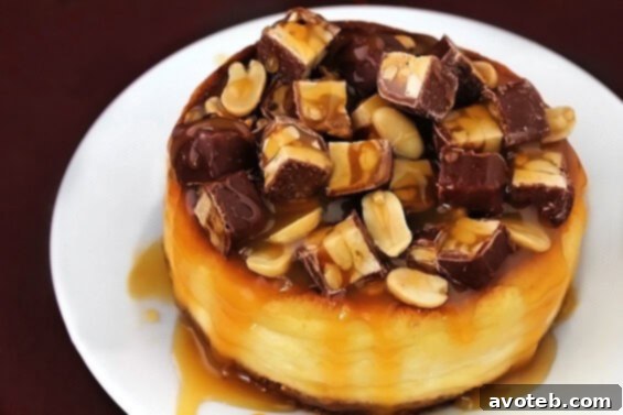 Rich and decadent Snickers Cheesecake, topped with delicious caramel sauce