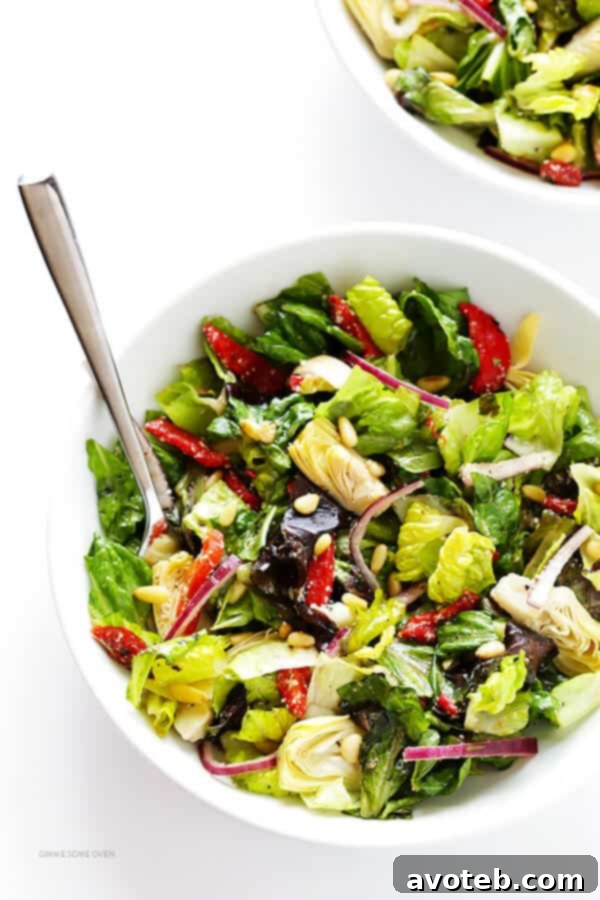 The Family's Favorite Salad, perfectly tossed with its zesty Parmesan red wine vinaigrette, showcasing its readiness to be served.
