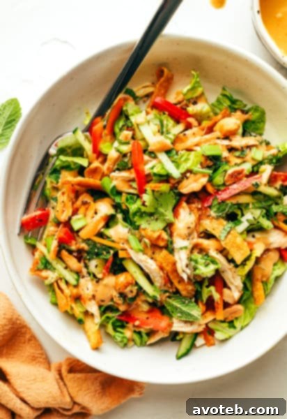 Final Thai Crunch Salad drizzled with peanut dressing in a bowl