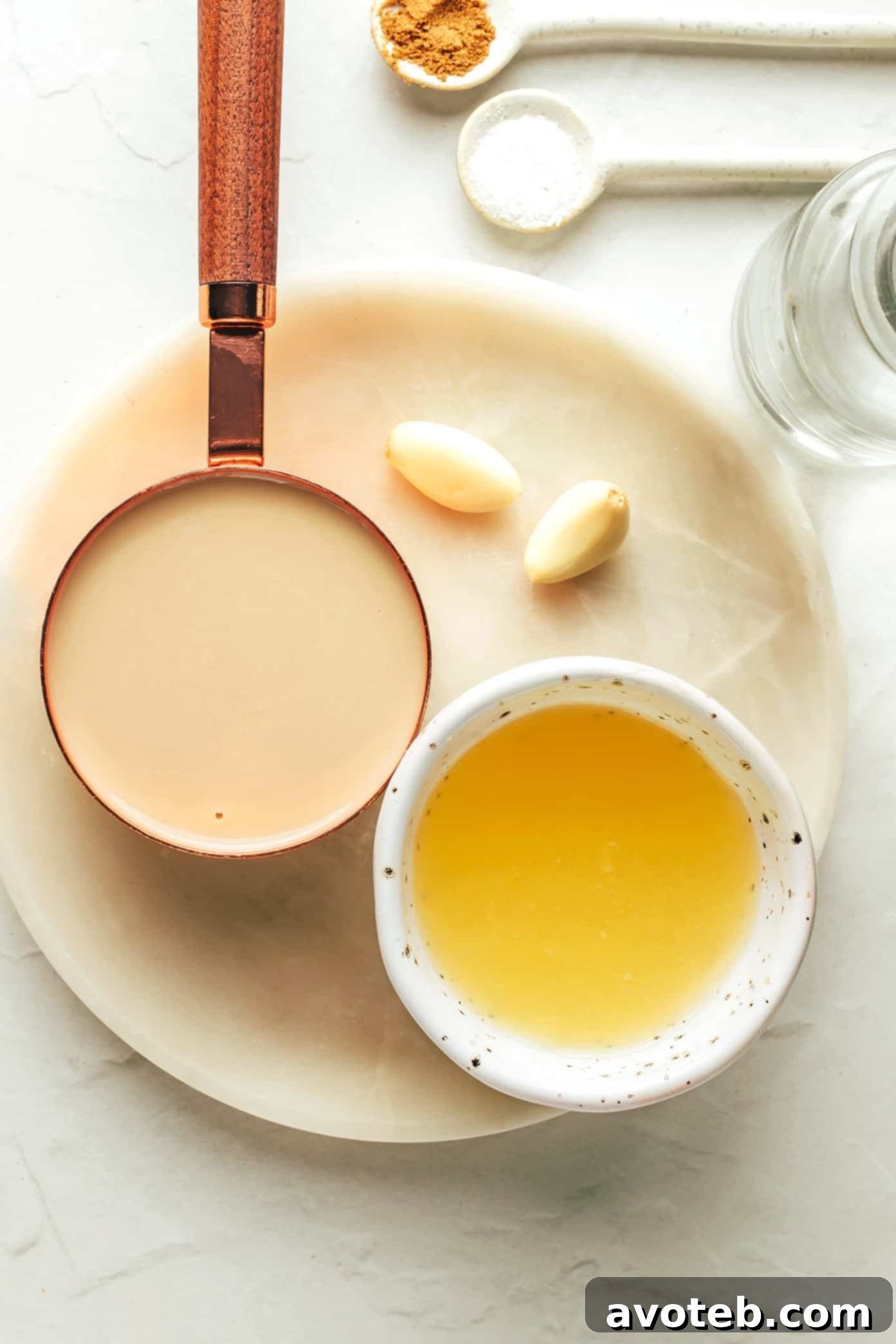 This homemade tahini sauce recipe is quick and easy to make with 5 ingredients and tastes amazing with everything from falafel to roasted veggies, grilled meats, wraps, salads and more. It's naturally gluten free and vegan, and easy to customize with extra herbs, spices or sweetener if you'd like. | gimmesomeoven.com Individual ingredients for tahini sauce including tahini, lemon, garlic, cumin, and salt
