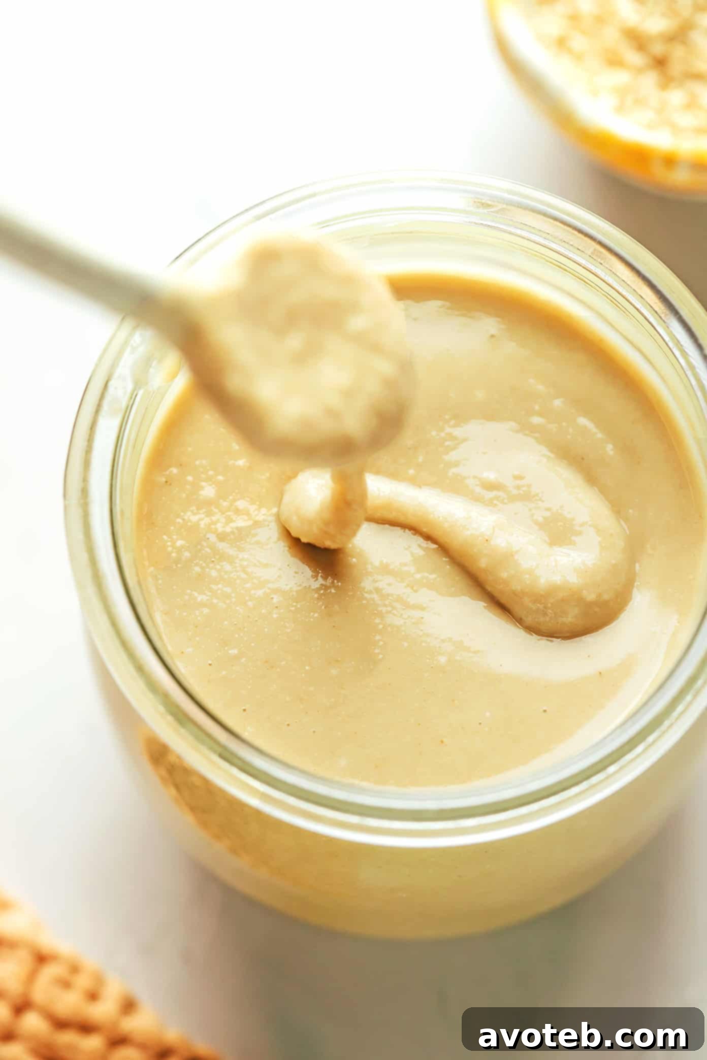 Homemade tahini drizzled into a jar