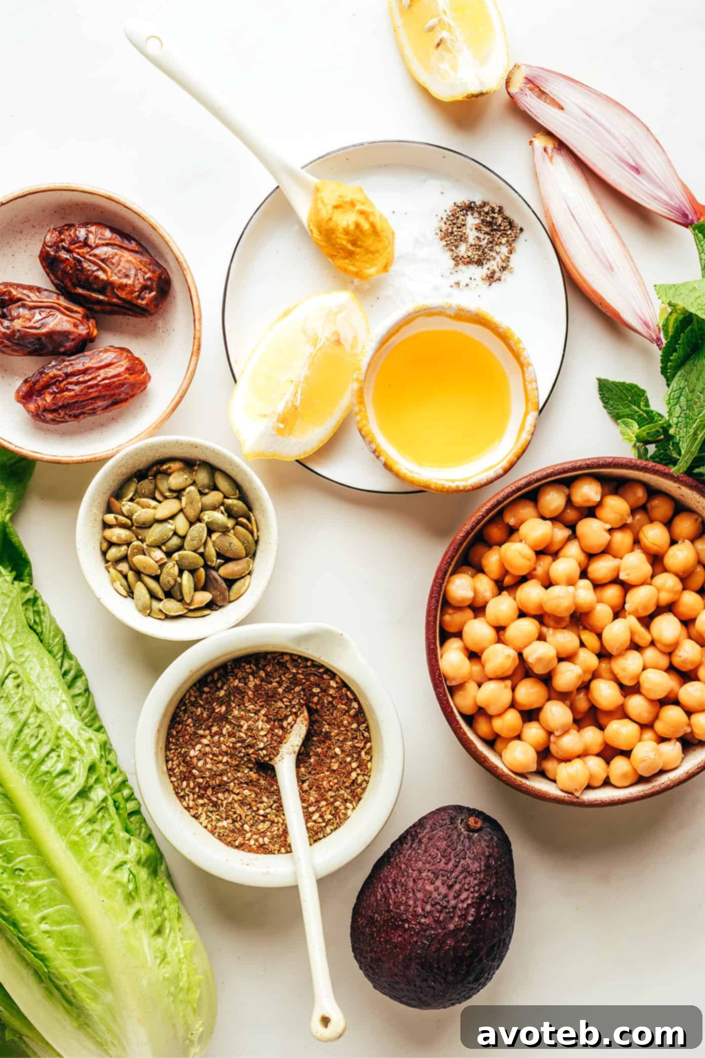 This vibrant green salad is loaded up with chickpeas, Medjool dates, avocado, pepitas, loads of fresh mint, and tossed with a lemony za'atar shallot vinaigrette. It's naturally vegan and gluten-free, but feel free to add a protein such as chicken, steak, shrimp or salmon if you'd like. So fresh and delicious! | gimmesomeoven.com Fresh Salad Ingredients laid out for preparation