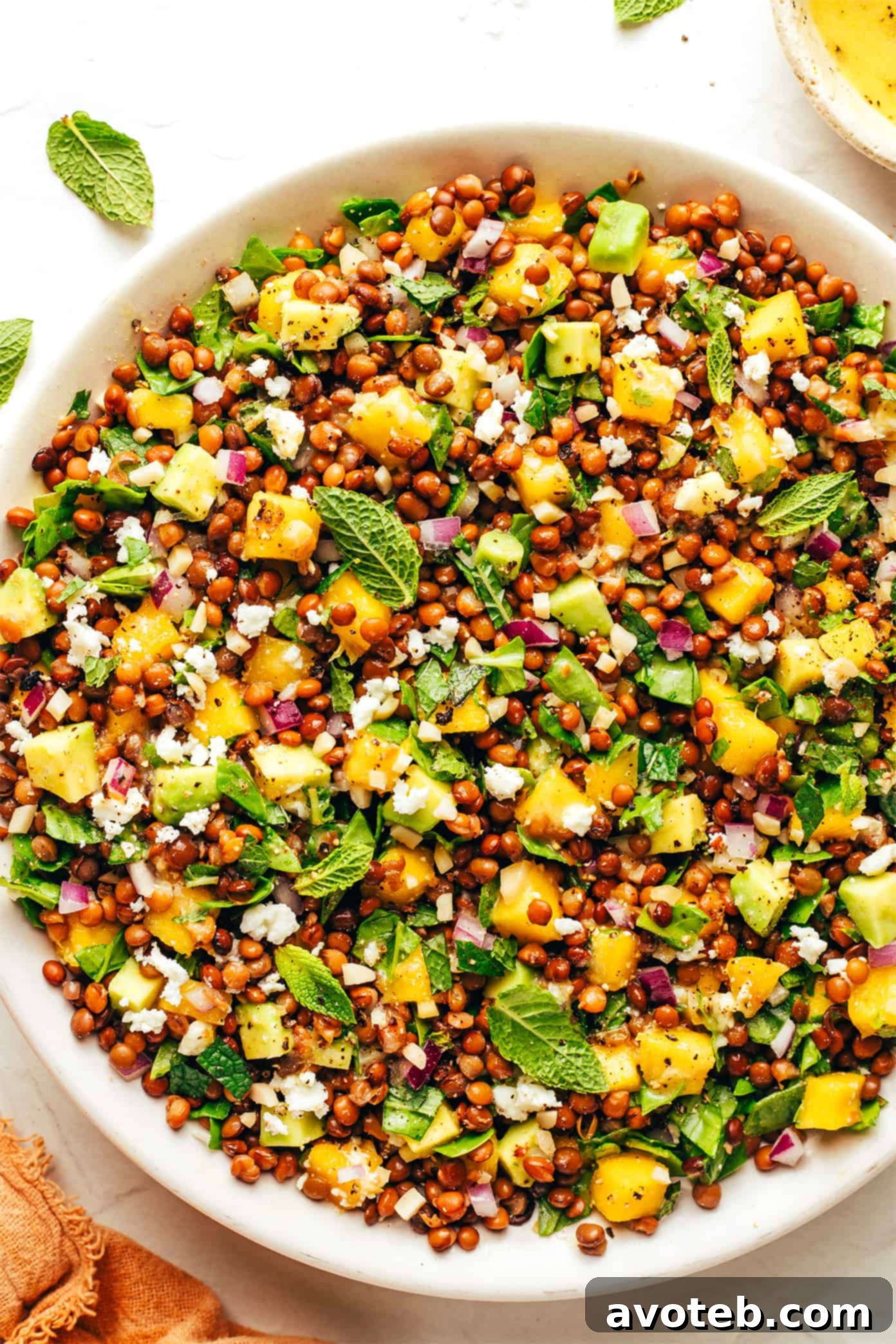 A vibrant and fresh mango lentil salad in a large serving bowl, ready to be enjoyed.