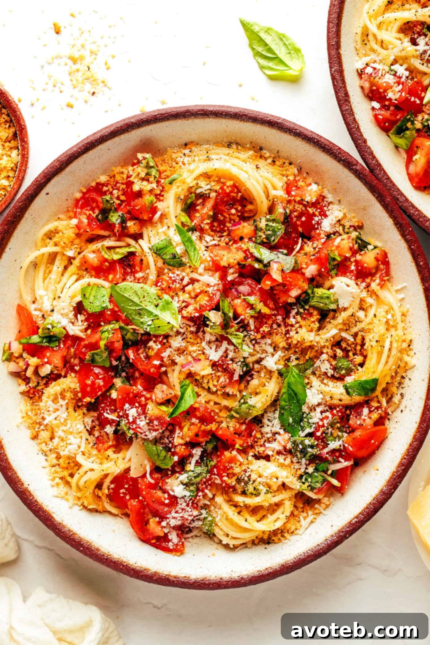 A beautifully plated bowl of Bruschetta Pasta, showcasing fresh cherry tomatoes, basil, and golden breadcrumbs.