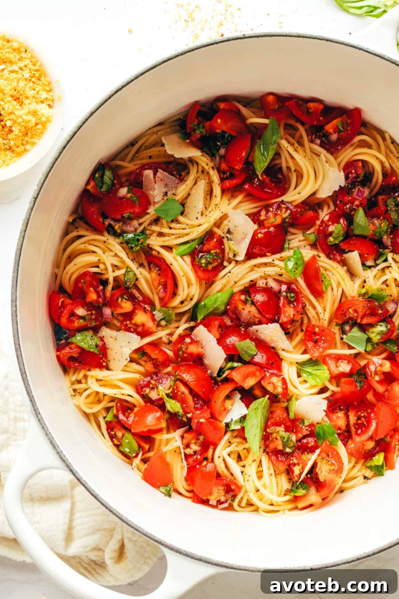 A bowl of Bruschetta Pasta with a serving spoon, ready to be enjoyed.