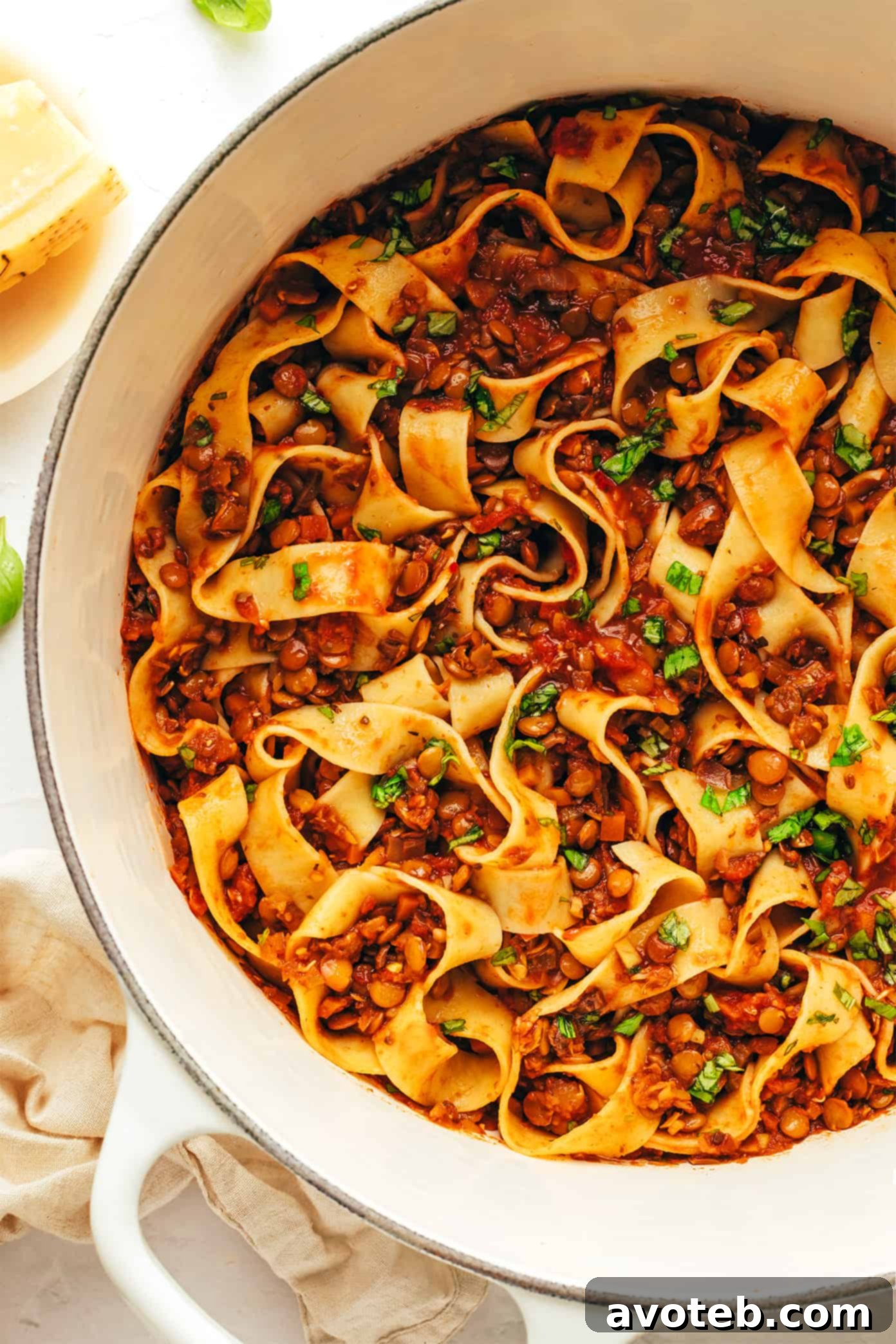A vibrant bowl of vegetarian pasta bolognese, garnished with fresh basil, showcasing the rich, hearty, and plant-based sauce with garlicky mushroom-herb tomato flavors. Vegetarian Pasta Bolognese served in a bowl with fresh basil