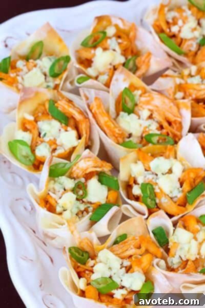 Delicious Buffalo Chicken Wonton Cups on a serving platter with a blue cheese dressing on the side