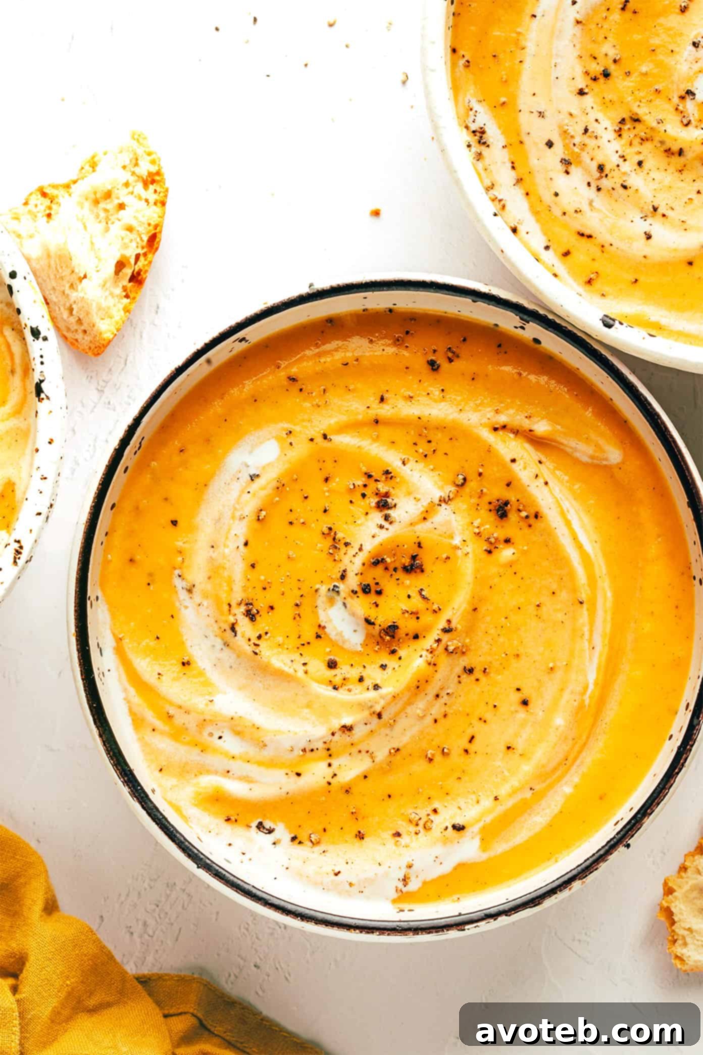 Overhead shot of creamy vegetable soup in a pot and a bowl