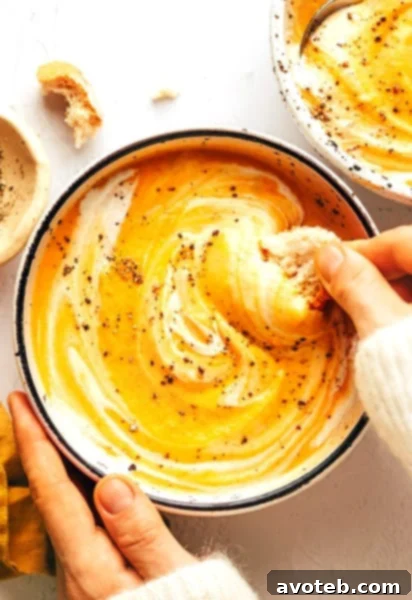 Creamy Roasted Vegetable Soup in a bowl with crusty bread