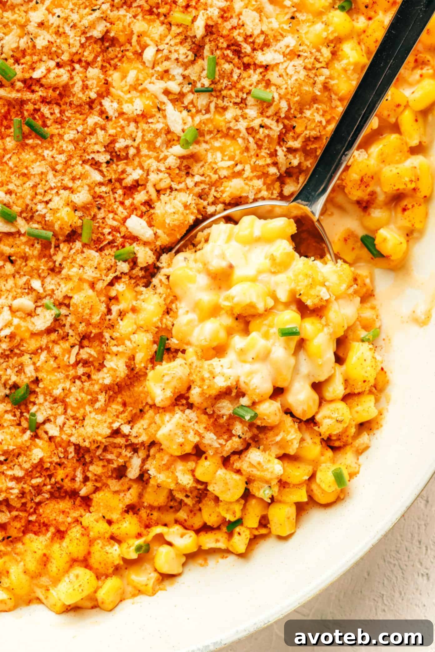 Closeup of Parmesan Creamed Corn, showing the creamy texture, corn kernels, and crisp garlic breadcrumbs.