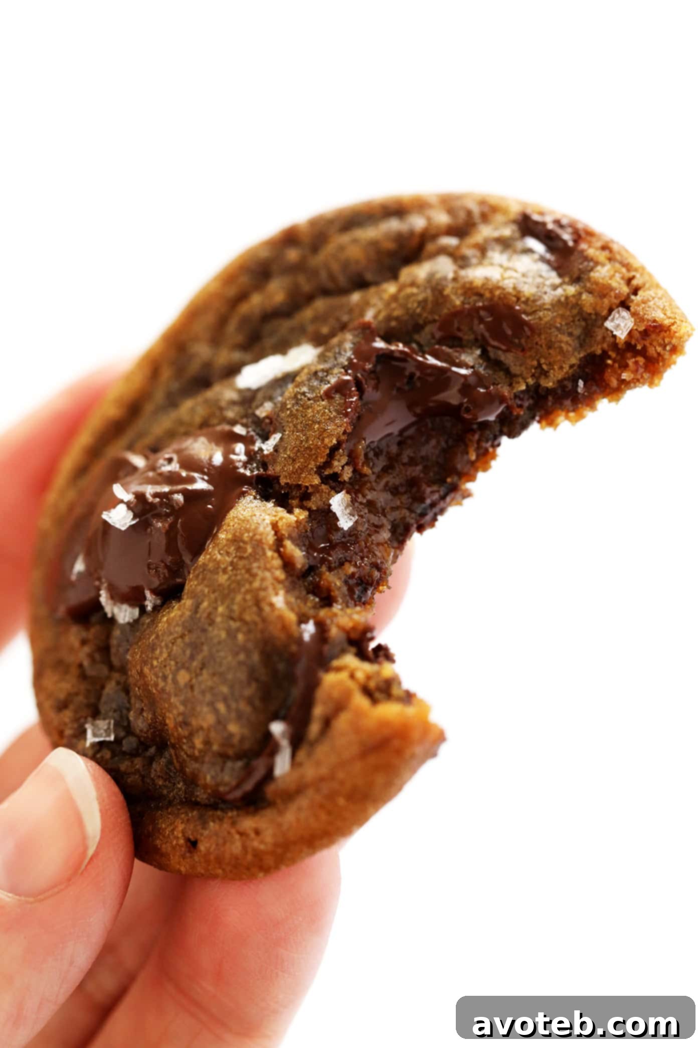 A close-up shot of a single Espresso Chocolate Chip Cookie, showing its soft interior and melted chocolate