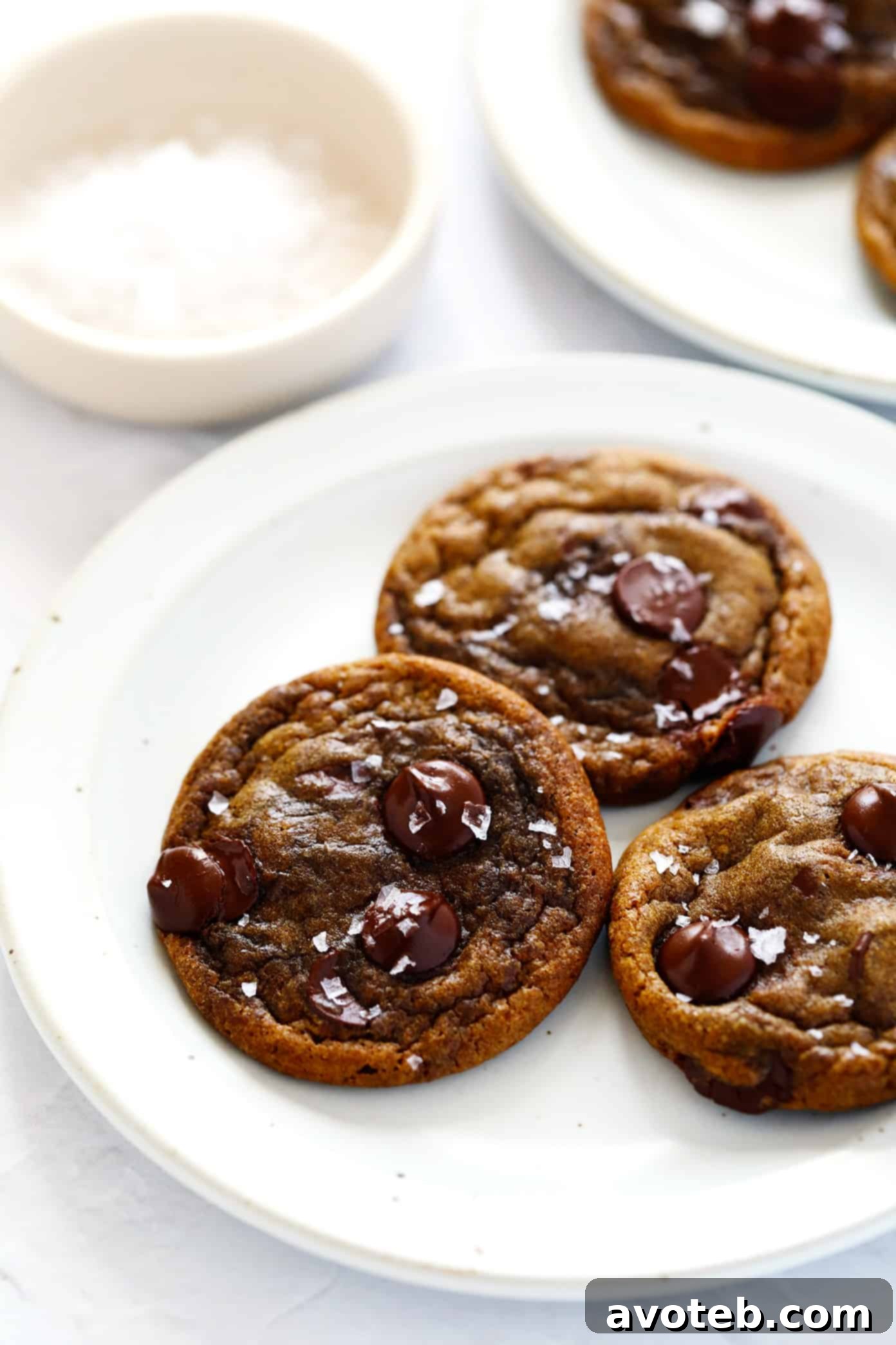 A stack of Espresso Chocolate Chip Cookies with a cup of coffee