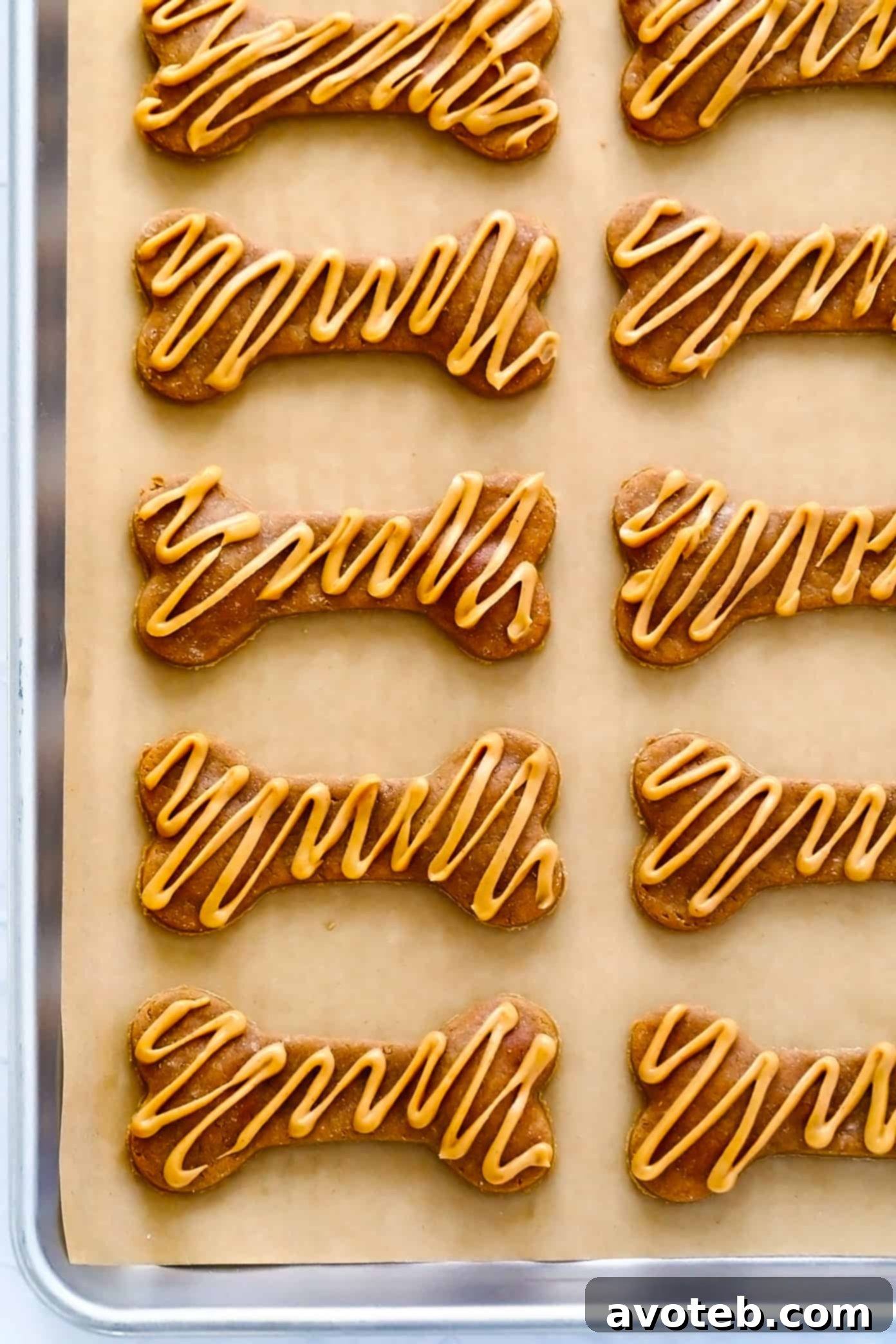 Delicious 3-ingredient homemade dog treats cut into cute bone shapes.