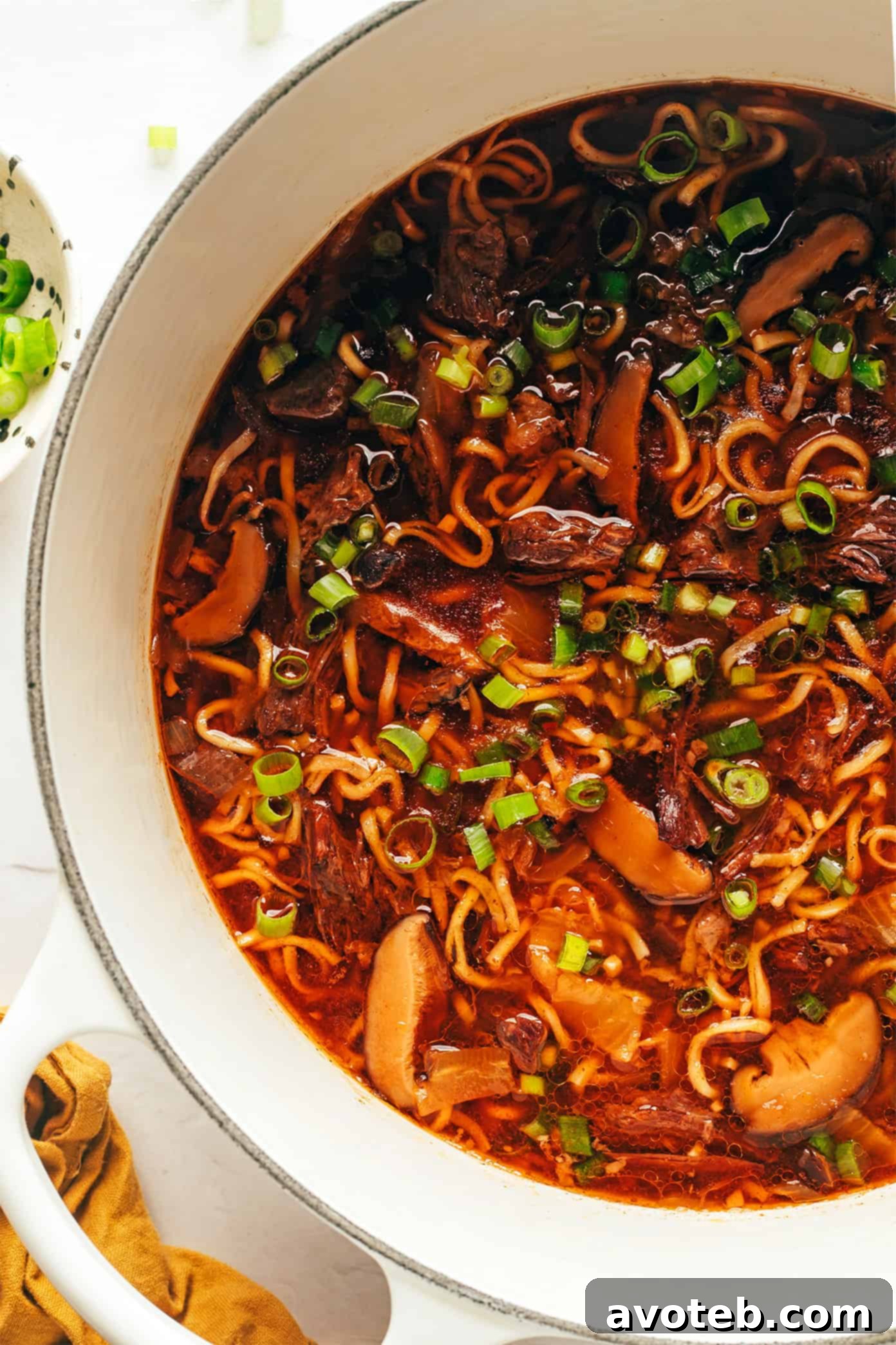 A final close-up of a vibrant bowl of Kimchi Beef Noodle Soup, highlighting its rich broth and toppings