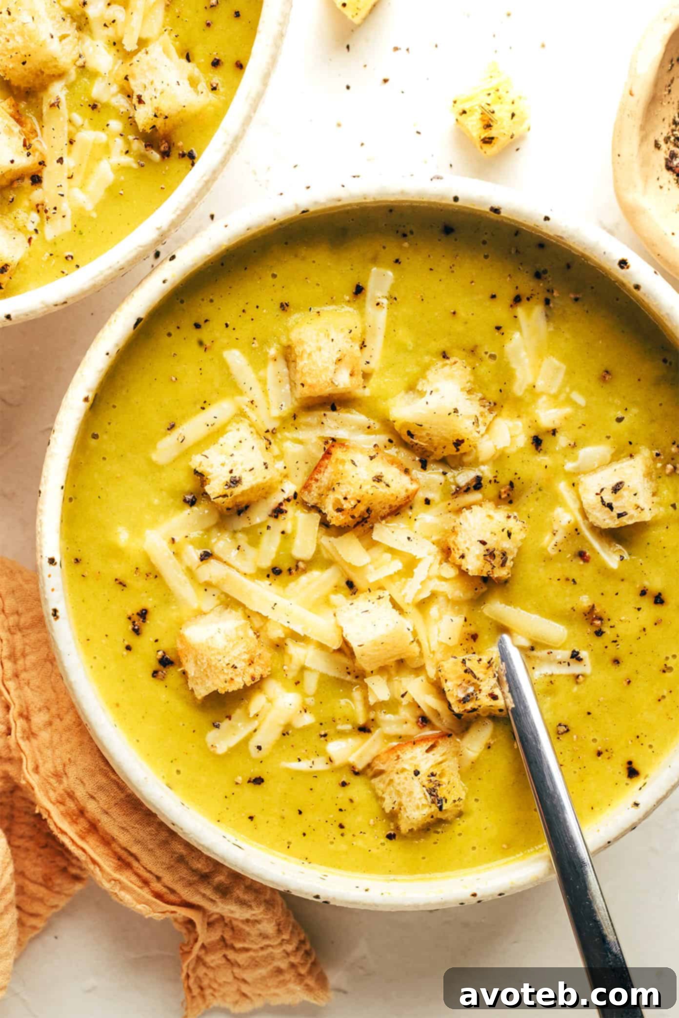 A final close-up of a generous serving of lightened-up broccoli cheese soup, ready to be enjoyed.