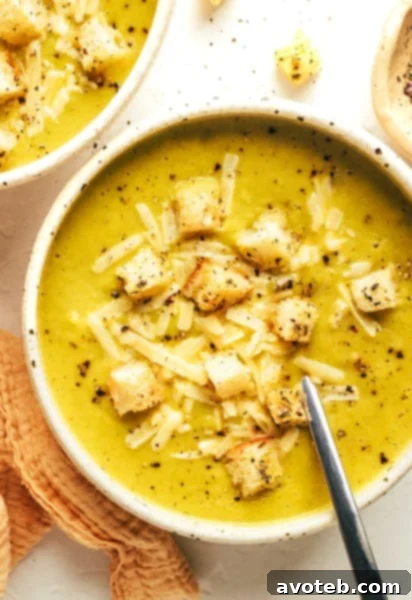 A vibrant, creamy lightened-up broccoli cheese soup in a rustic bowl, ready to be served.