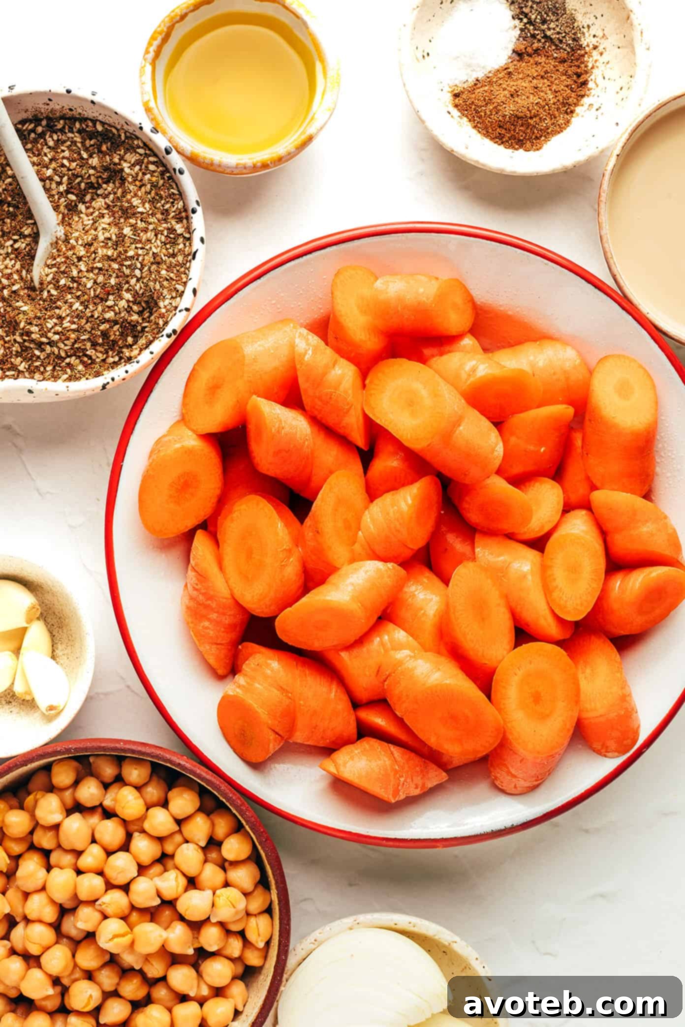 Closeup of roasted carrots and chickpeas on a baking sheet.