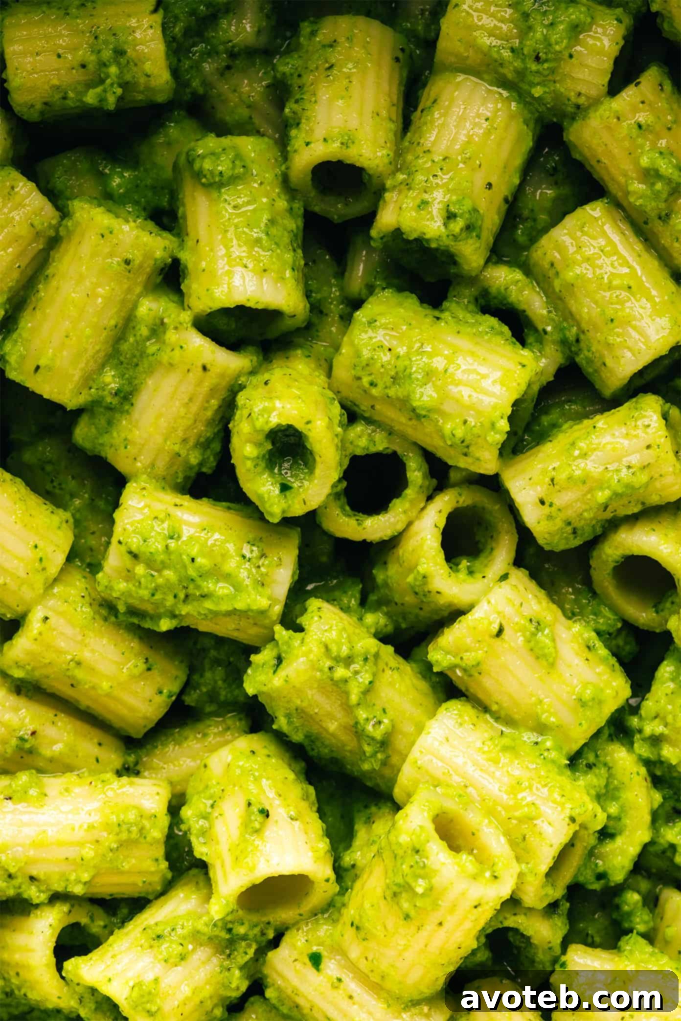 A serving of Lemony Broccoli Pesto Pasta in a white bowl, ready to eat.