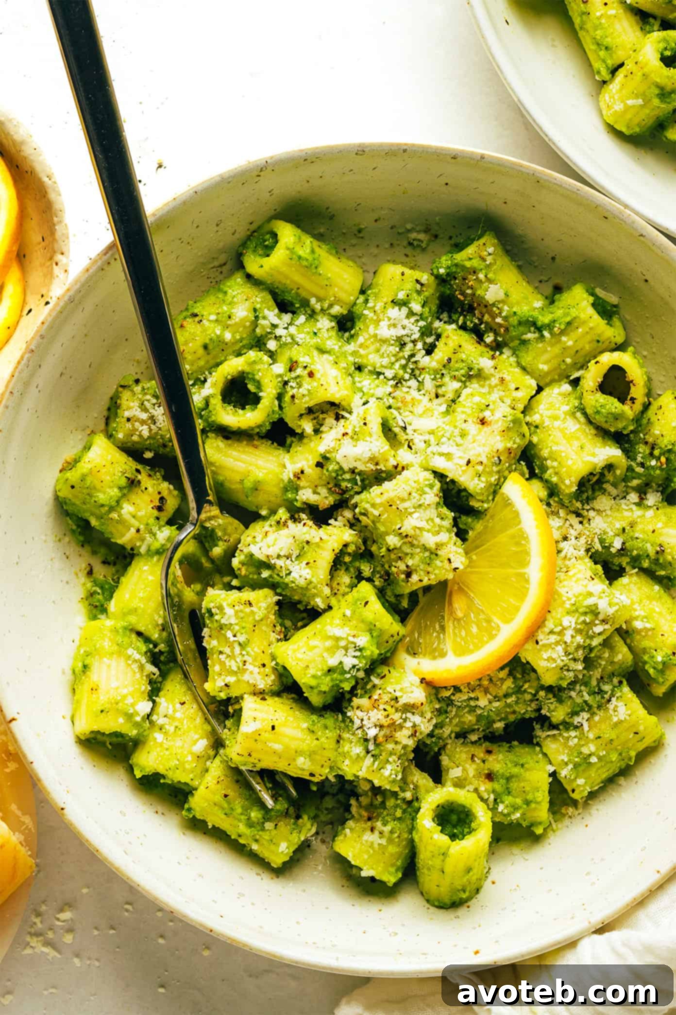 Final plated Lemony Broccoli Pesto Pasta, garnished with fresh herbs.