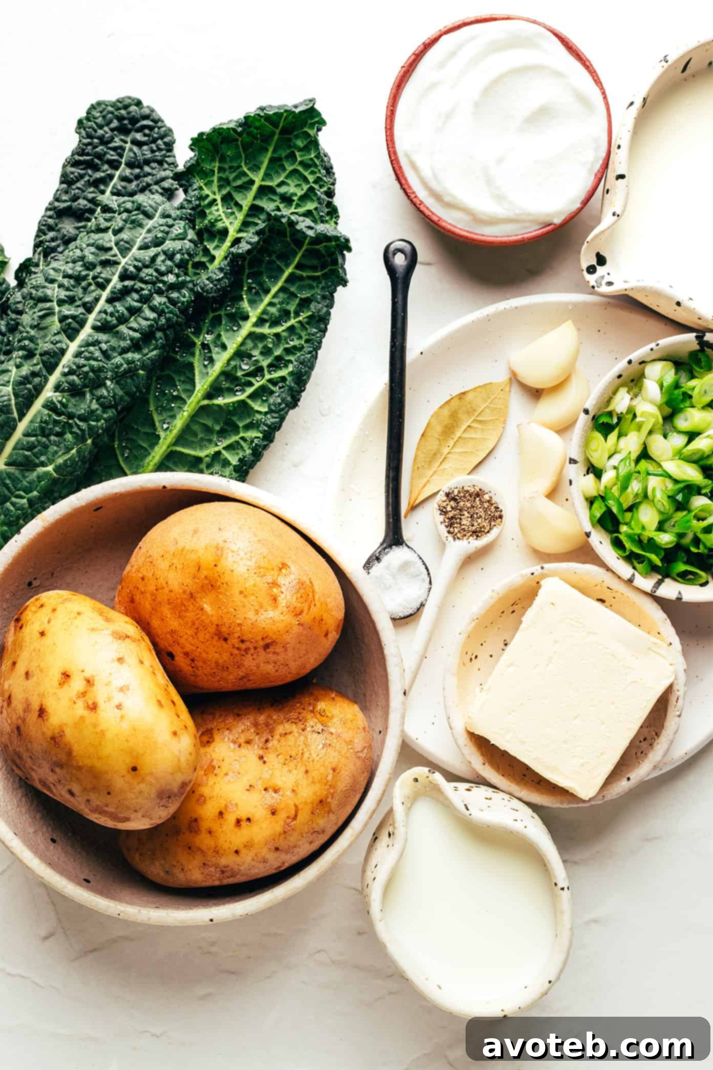 A close-up shot of creamy Colcannon with a swirl of butter and green onions.