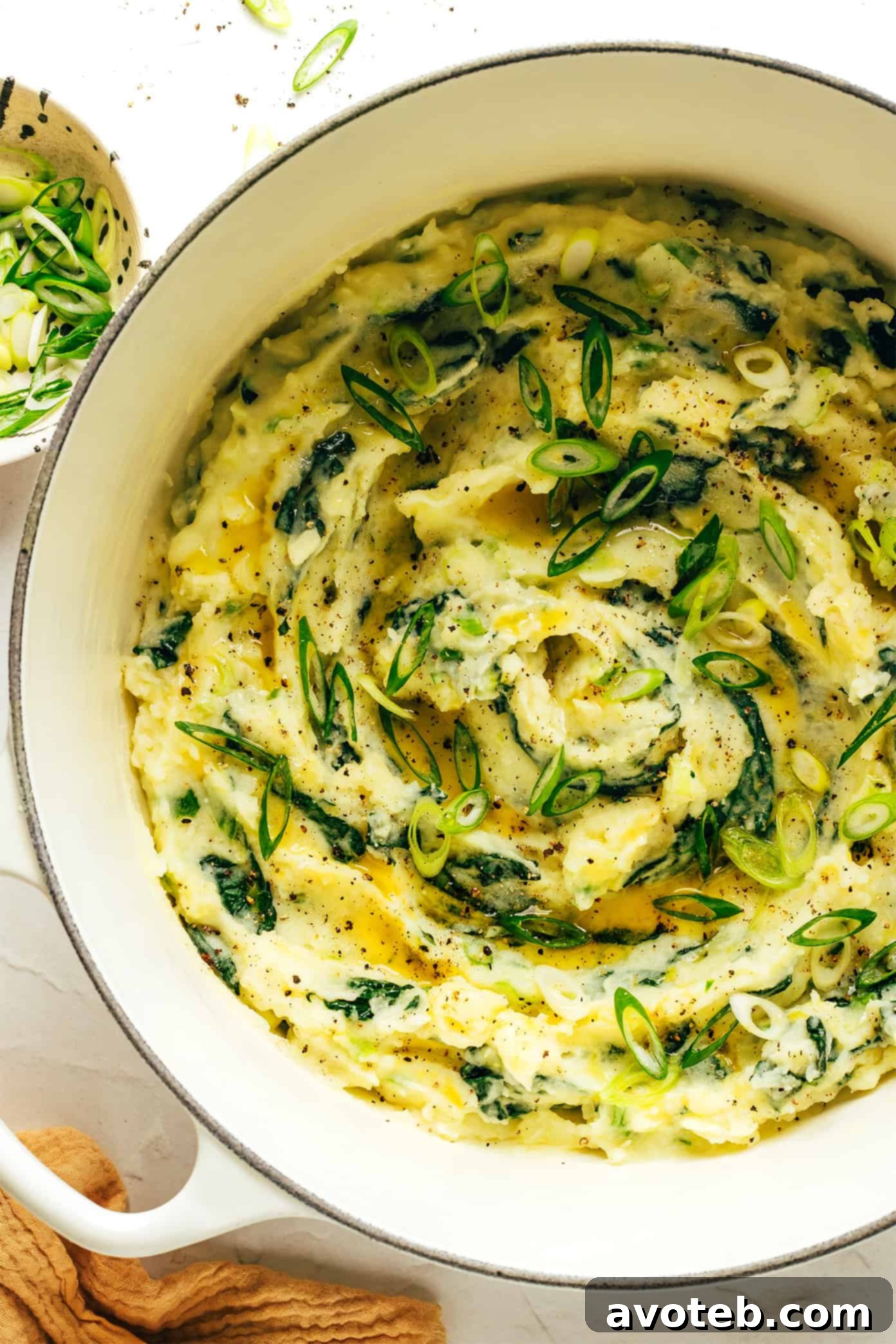 A bowl of freshly made Colcannon with a serving spoon.