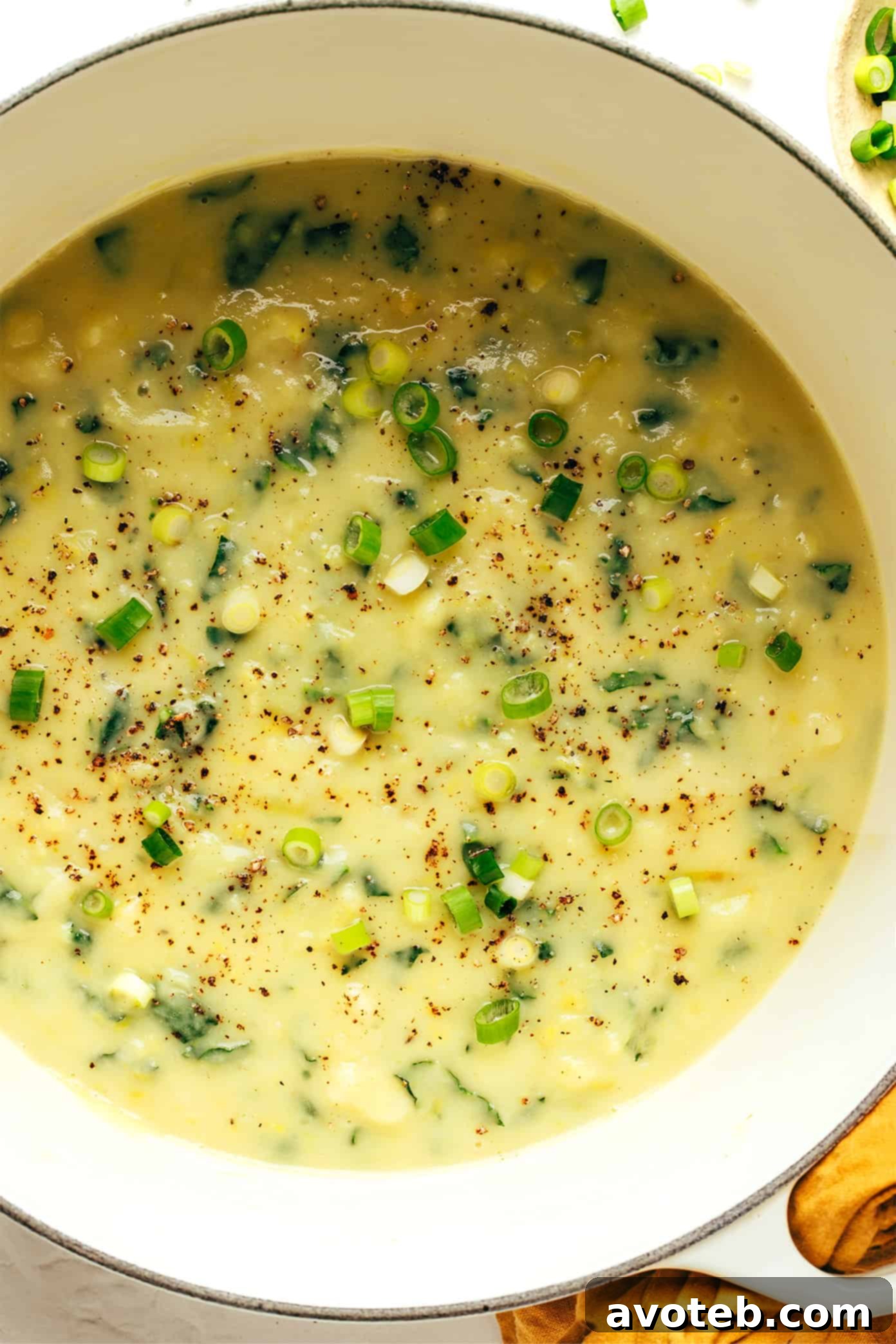 A close-up shot of the Colcannon Soup in a bowl, with a spoon revealing its creamy texture and bits of kale.