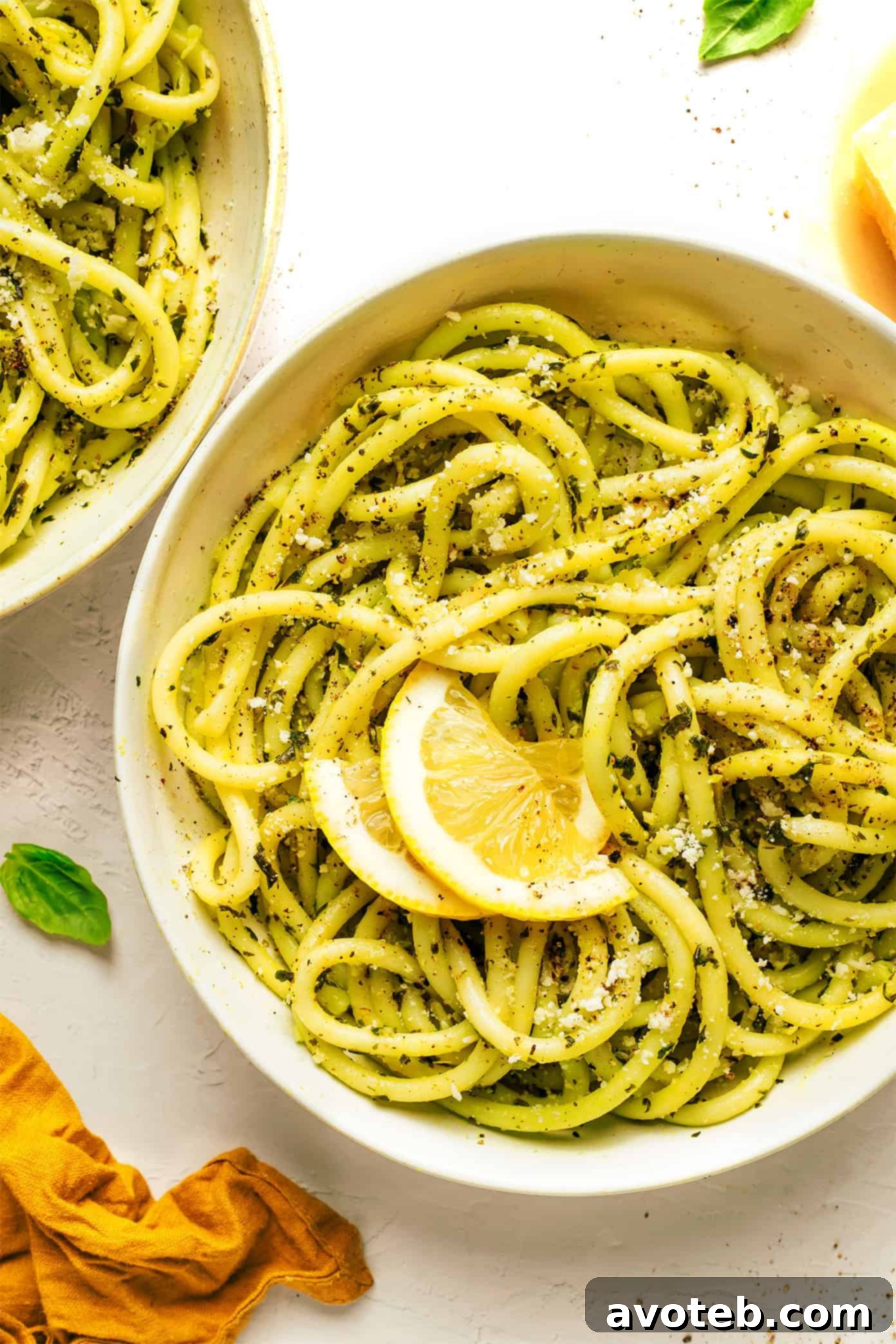 Lemon basil butter pasta served in a bowl, garnished with fresh basil and Parmesan